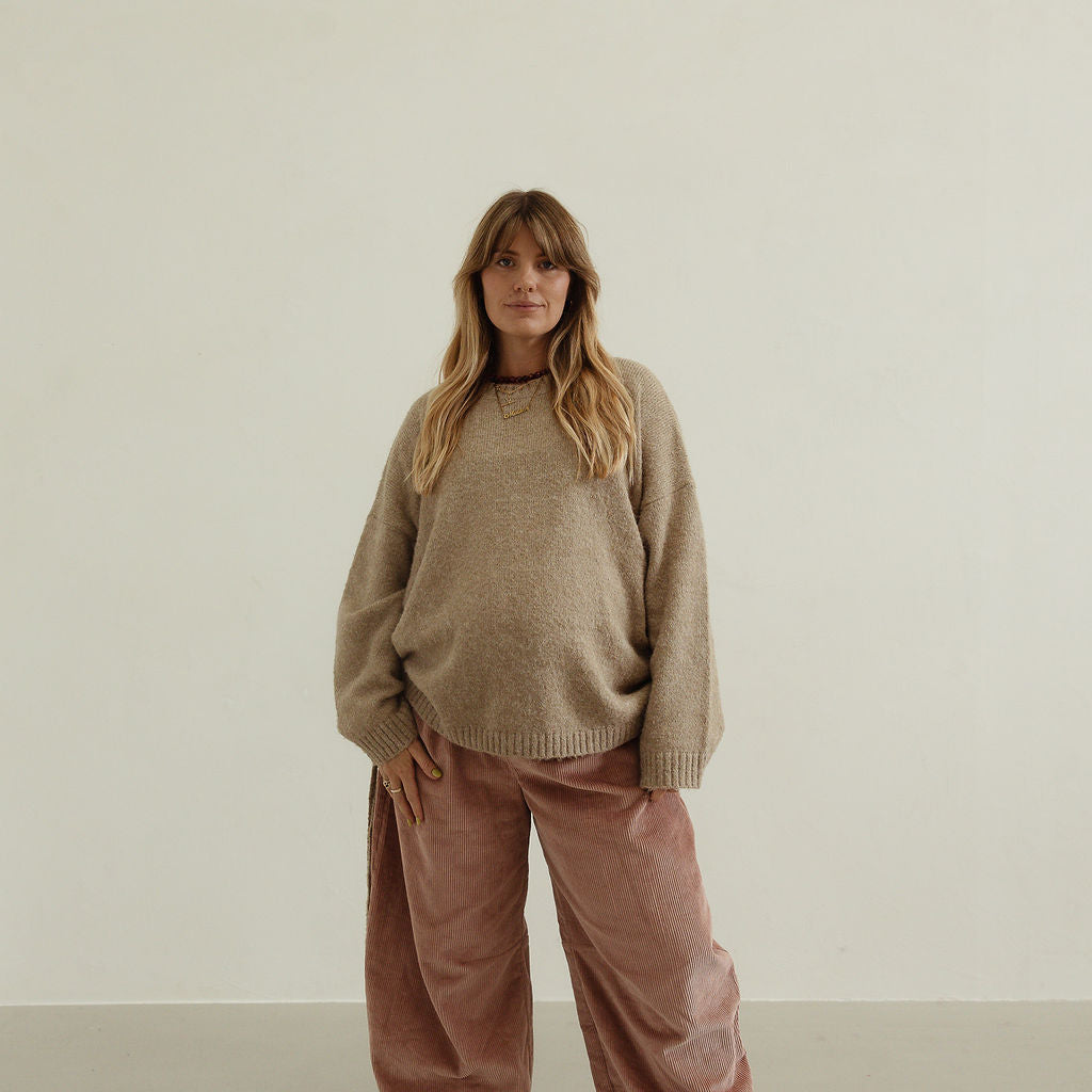 Front view of musk pink corduroy wide-leg pants with relaxed fit and soft drape