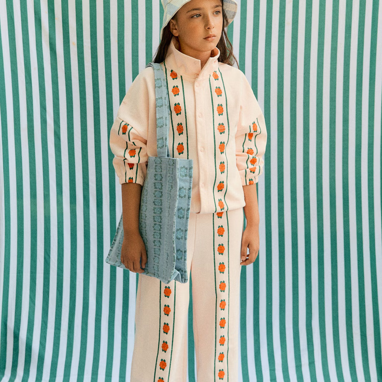 Girl wearing Roses Straight Sweatpant – Pastel Pink by Tiny Cottons