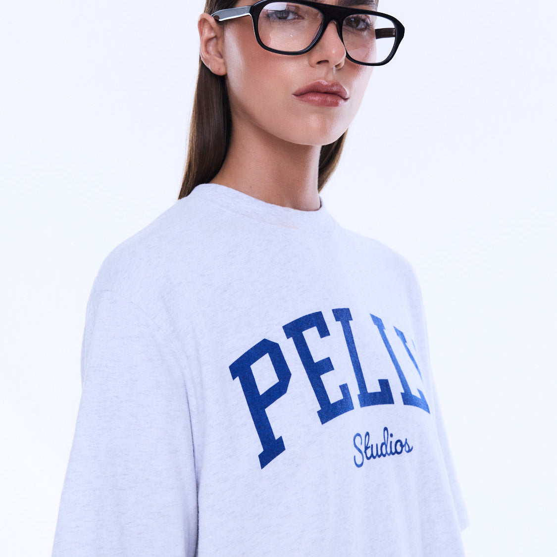 Front view of Sophia Relaxed Tee showing white cotton fabric with blue PELLY Studios graphic print and crew neck