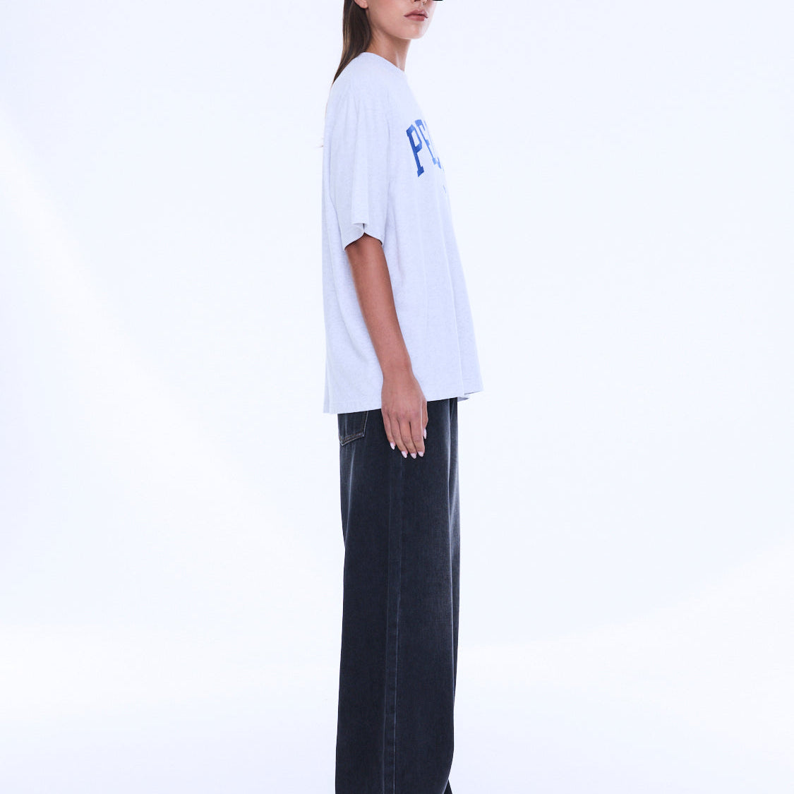 Side view of Sophia Relaxed Tee displaying oversized relaxed fit and short sleeve construction on white background