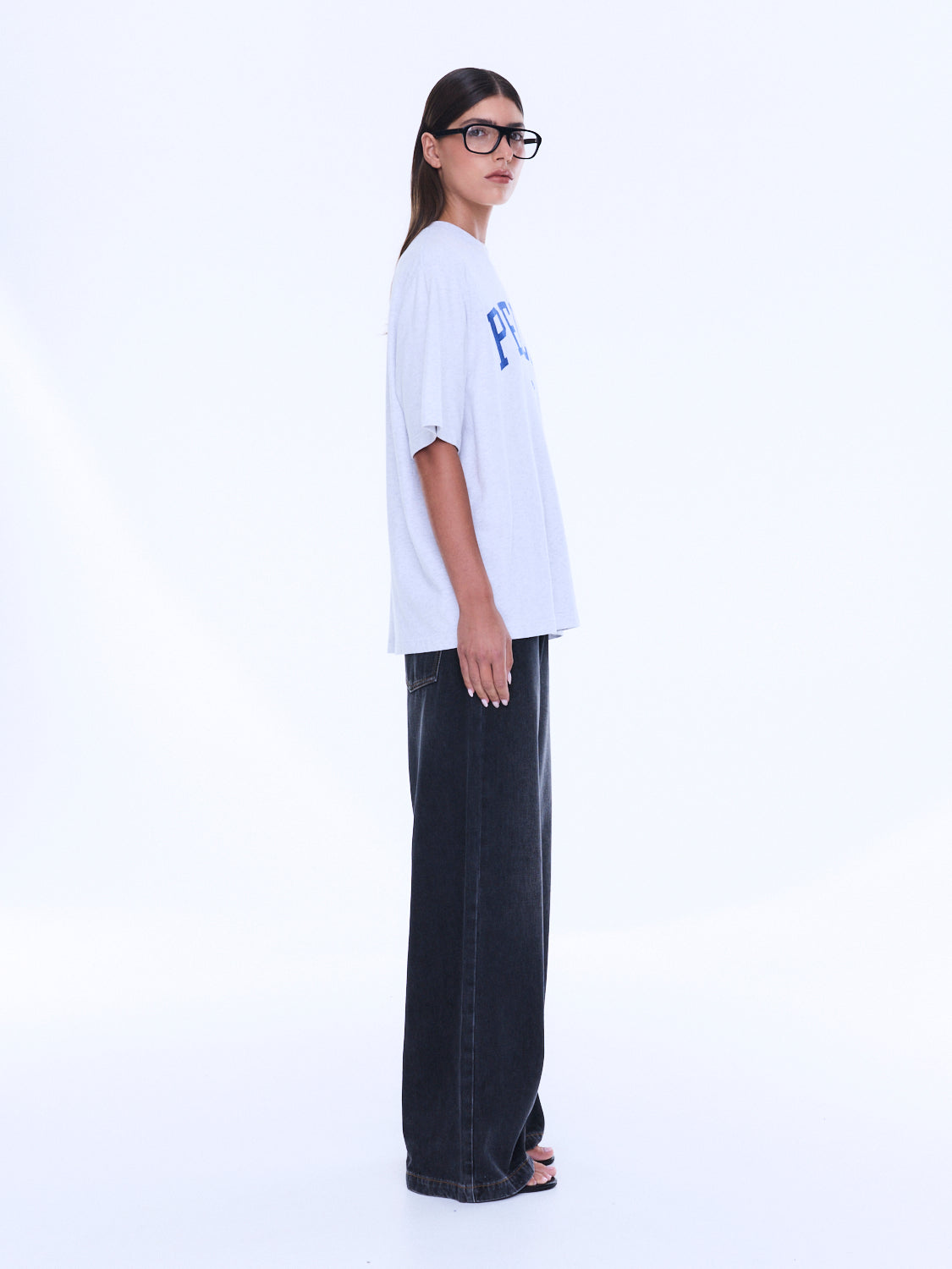 Side view of Sophia Relaxed Tee displaying oversized relaxed fit and short sleeve construction on white background