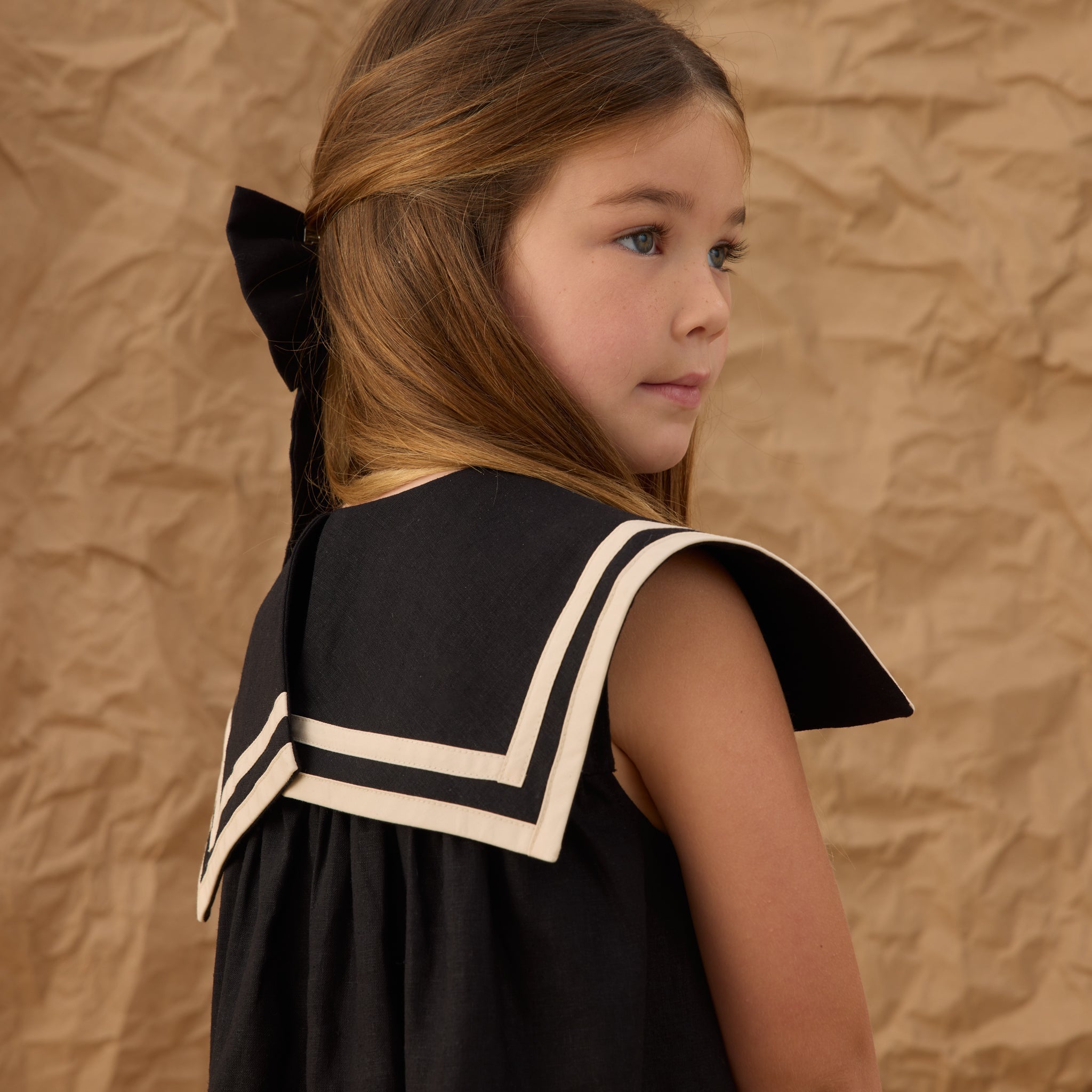 Back/side angle of the Sailor Dress Black | Rylee + Cru