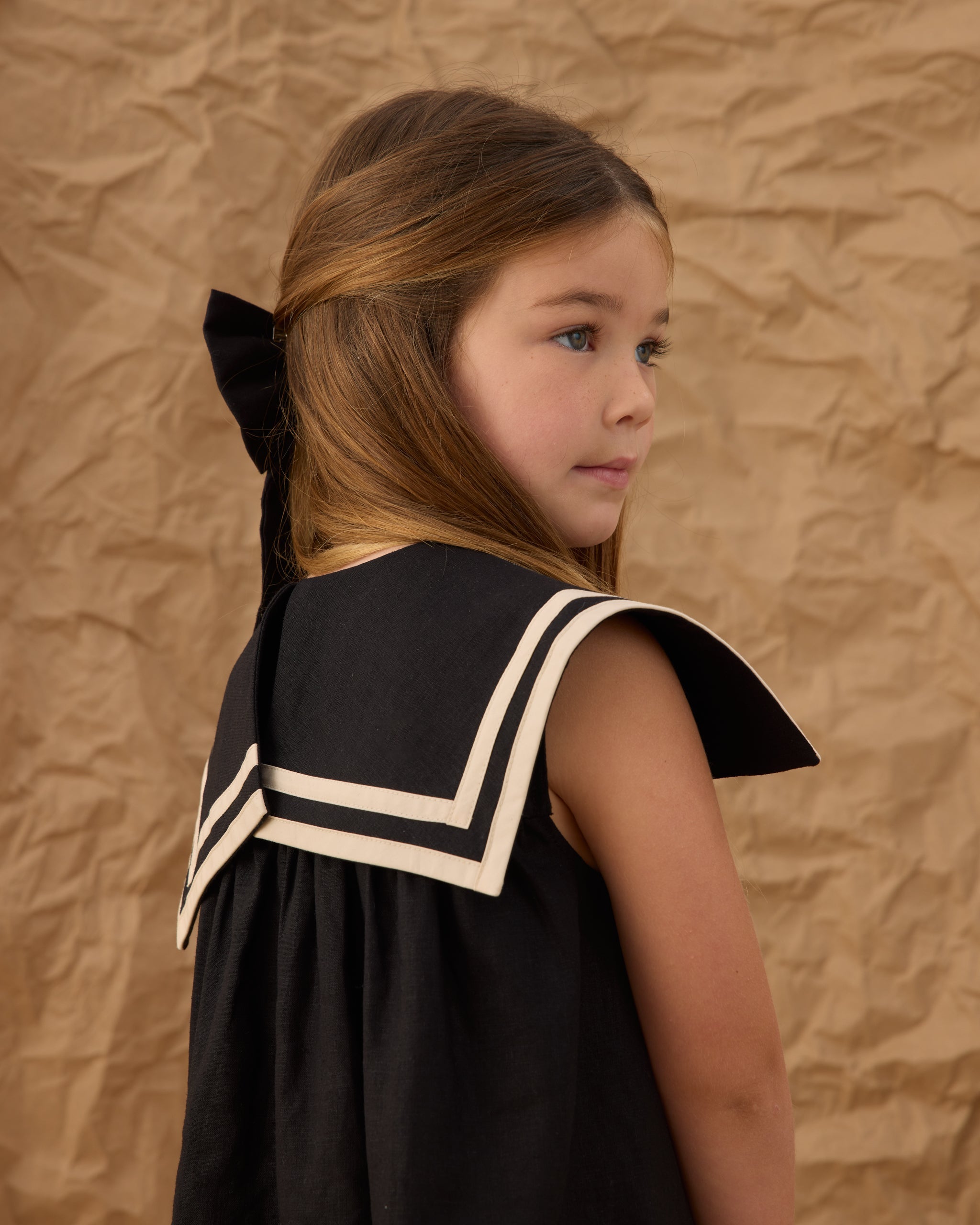 Back/side angle of the Sailor Dress Black | Rylee + Cru