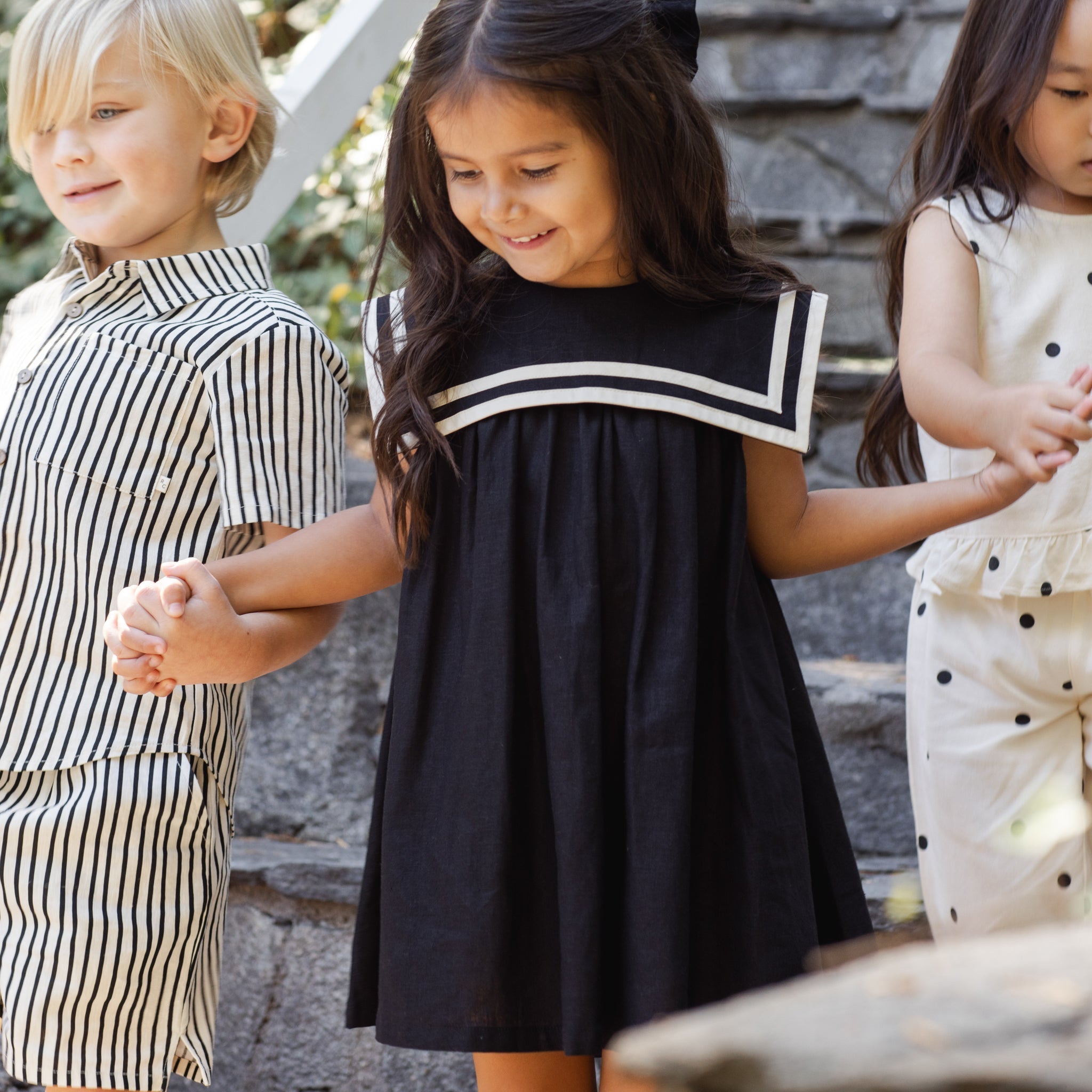 Front view of young girl in the Sailor Dress Black | Rylee + Cru
