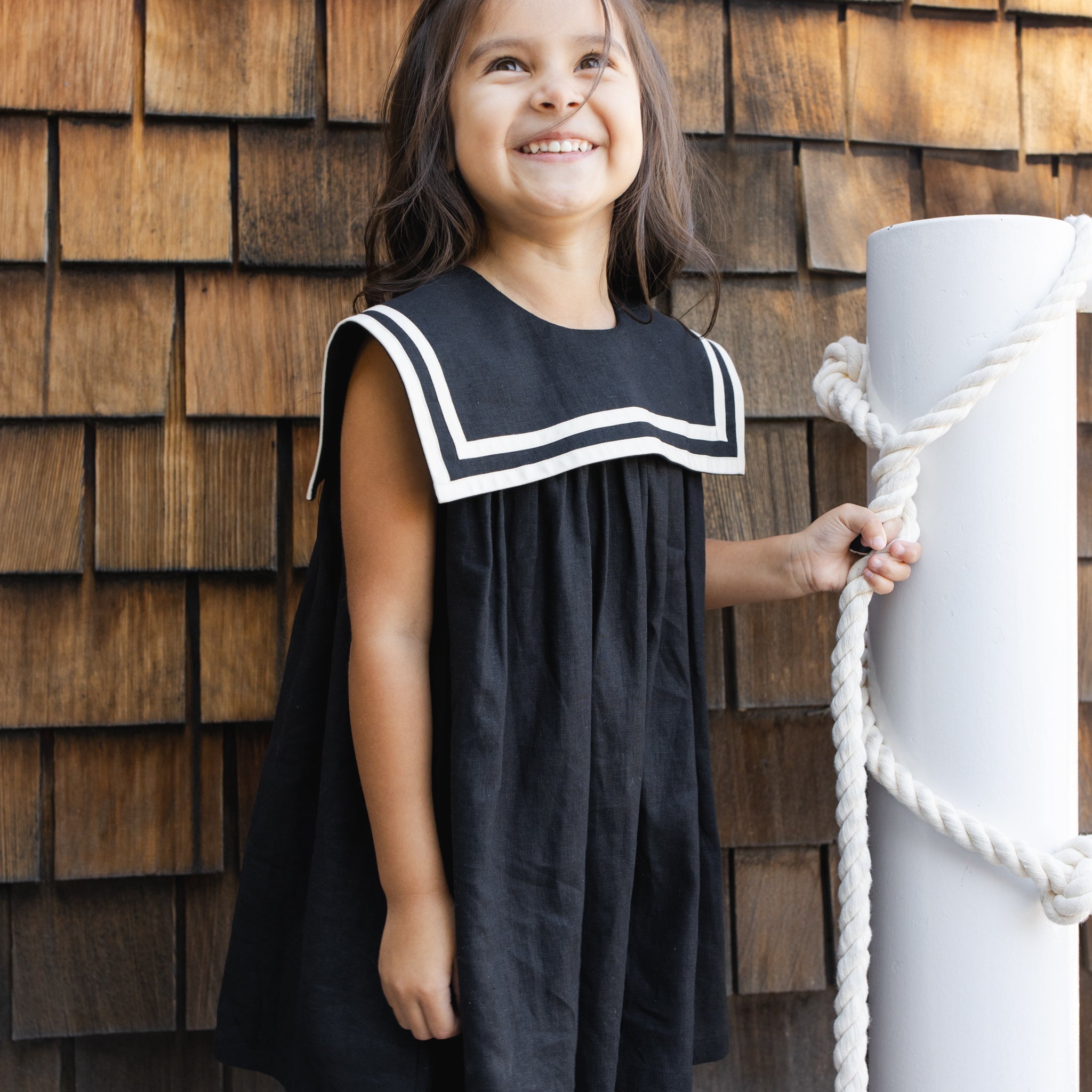 Girl wearing the Sailor Dress Black and white | Rylee + Cru