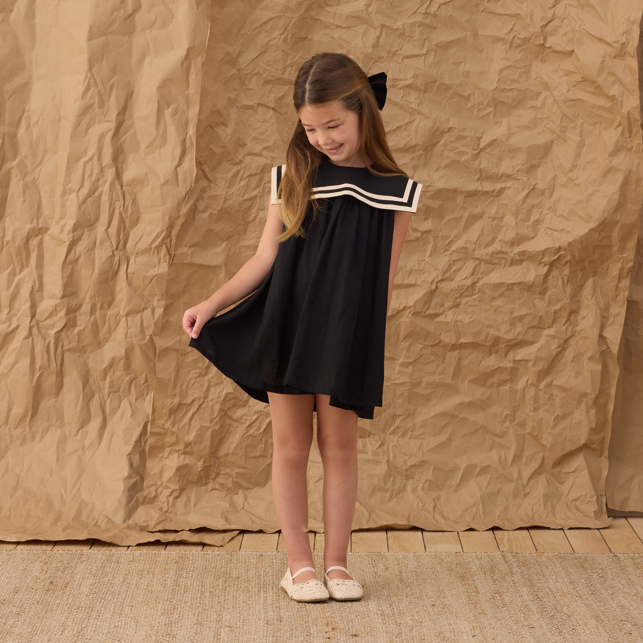 Young girl wearing the Sailor Dress Black | Rylee + Cru