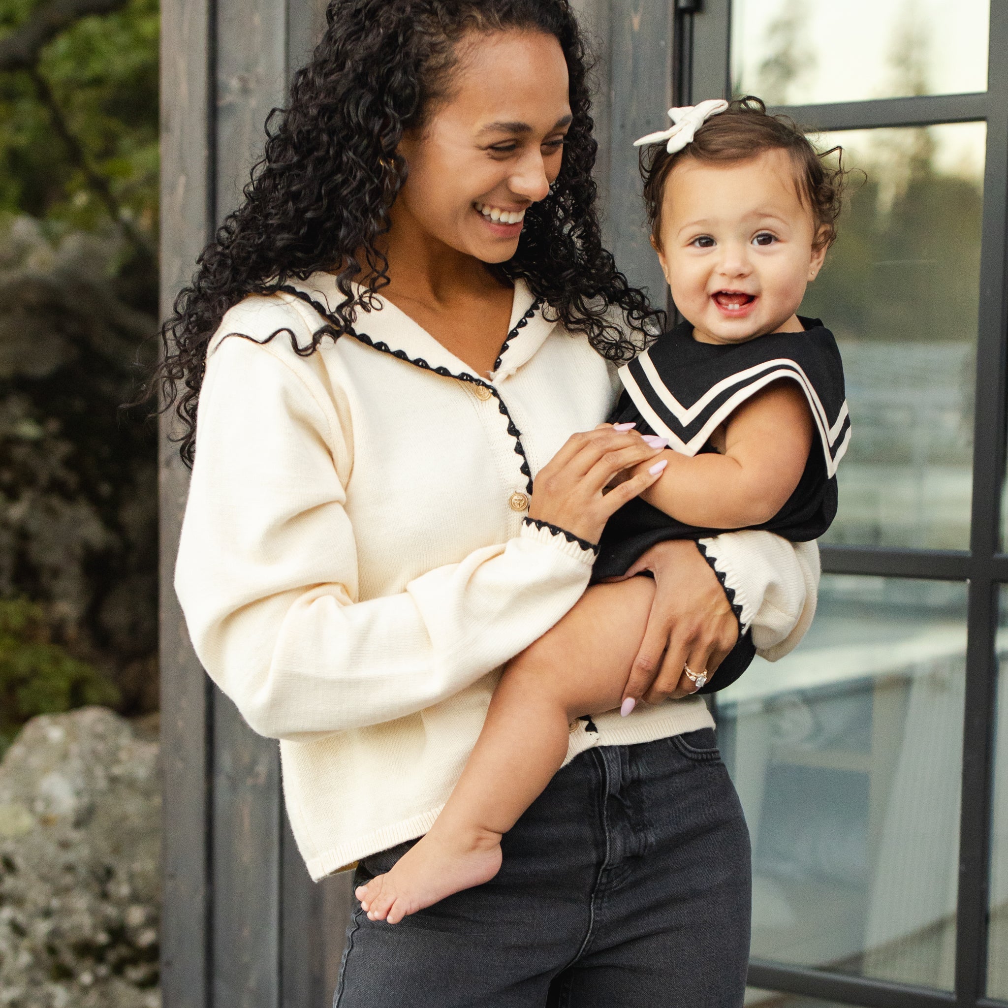 Baby wearing the Sailor Romper Black | Rylee + Cru