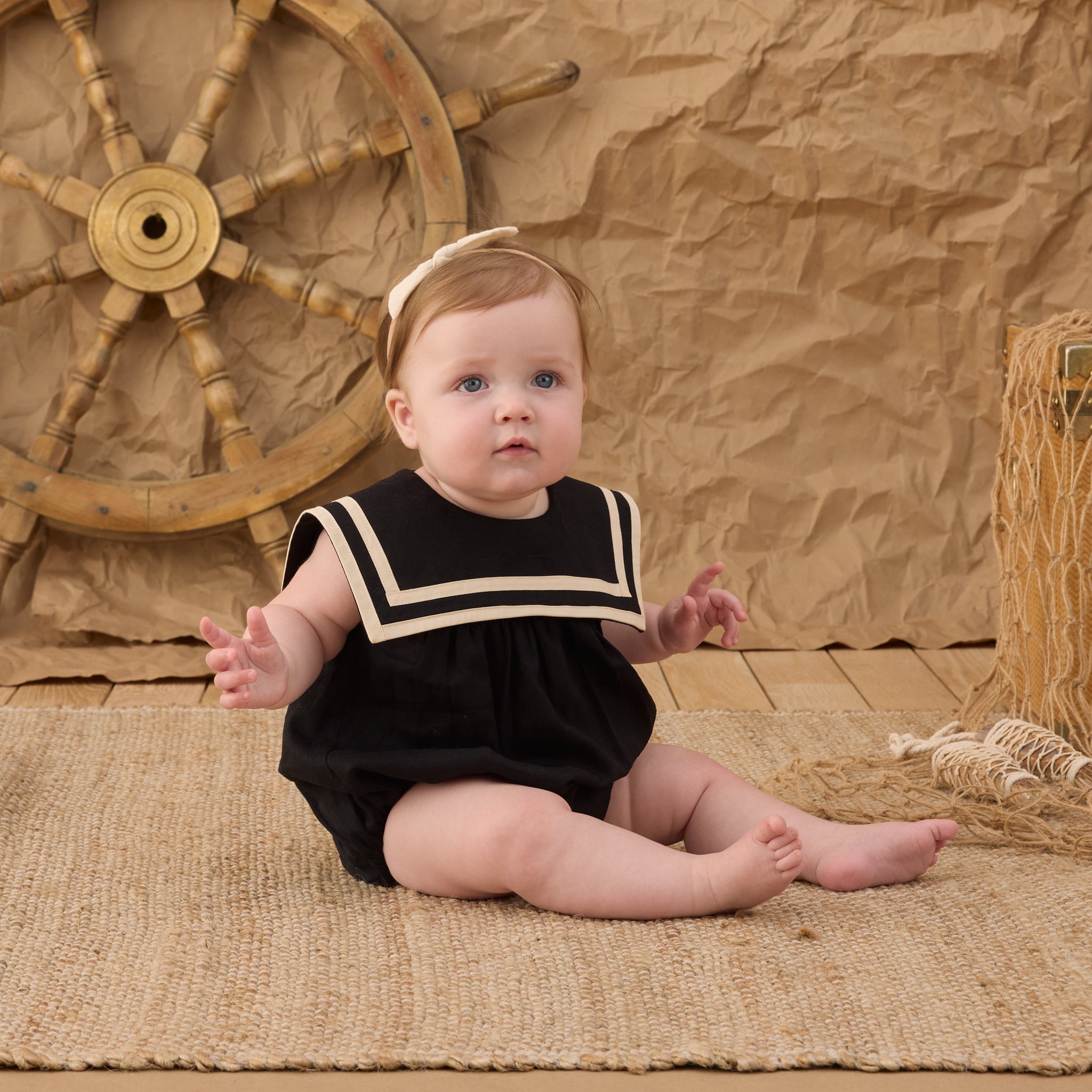 Baby wearing the Sailor Romper Black | Rylee + Cru