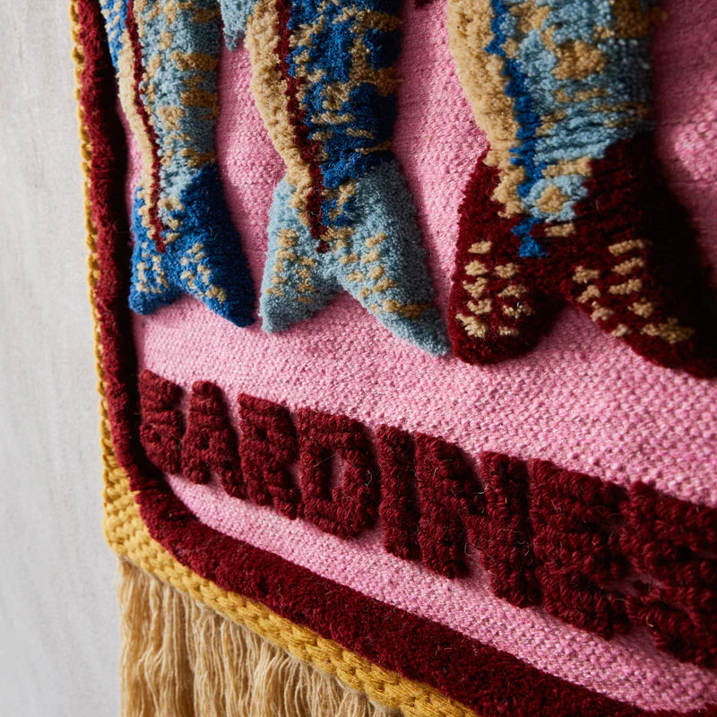 Fabric Detail of Sandria Woven Wall Hanging by Sage & Clare - pink woven wall hanging depicting sardines