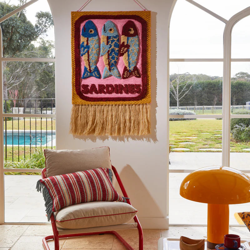 Sandria Woven Wall Hanging by Sage & Clare hanging on wall