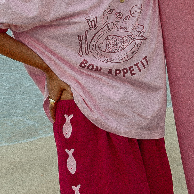 Maroon and pink pants with Sardines down the sides