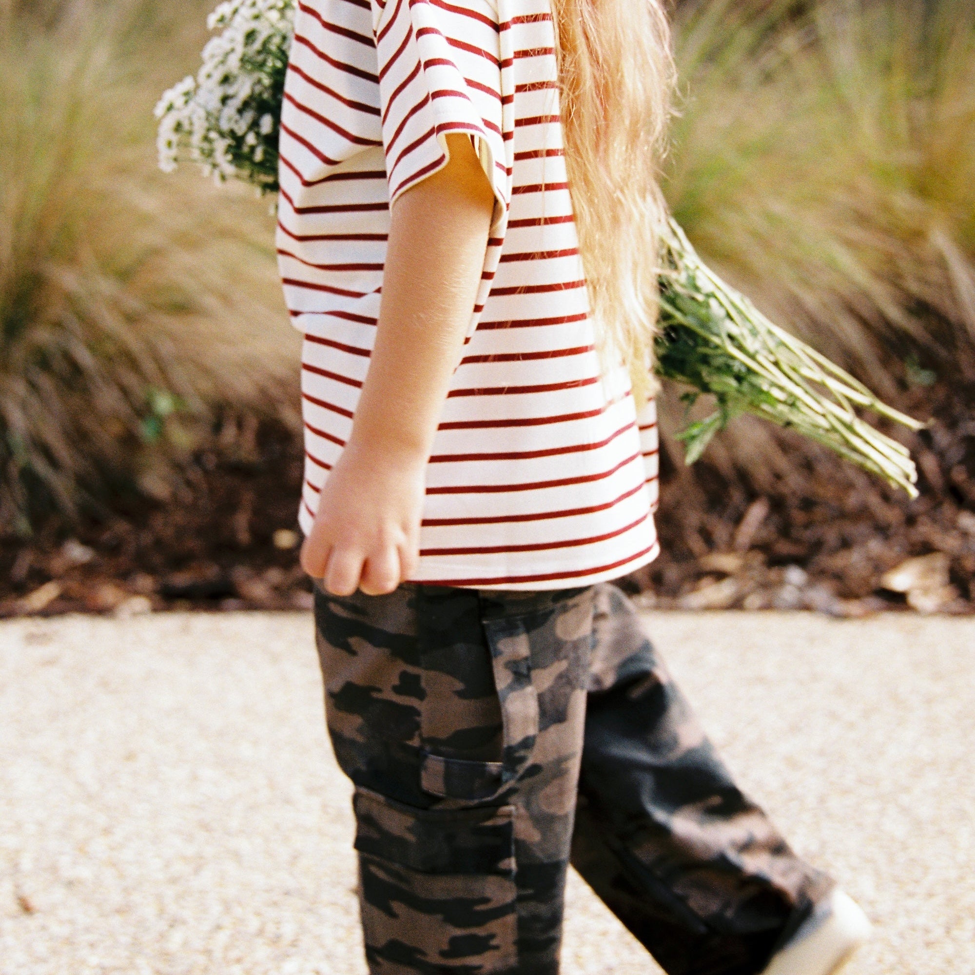 Side view of child in camo Scottie Pants cargo pants showing full length silhouette