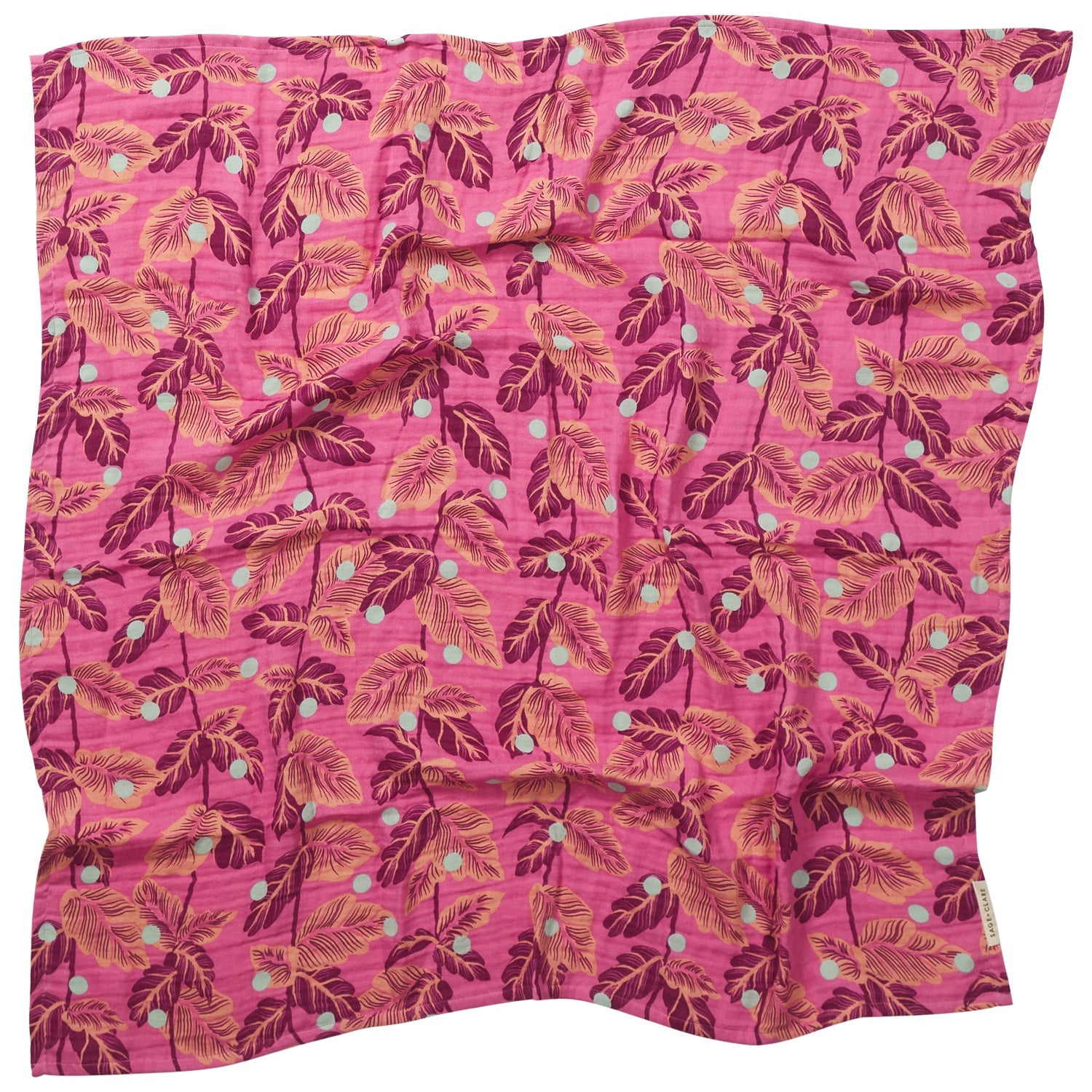 Full flat lay view of Sorana Baby Wrap showing complete tropical leaf pattern on pink background