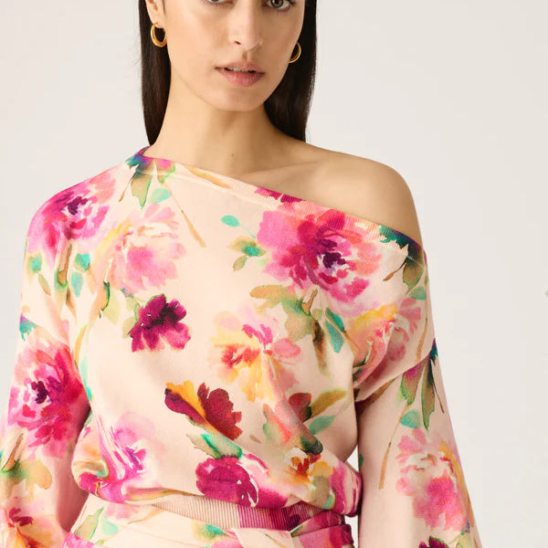 Model wearing off the should knit dress with floral print by MOS The label.