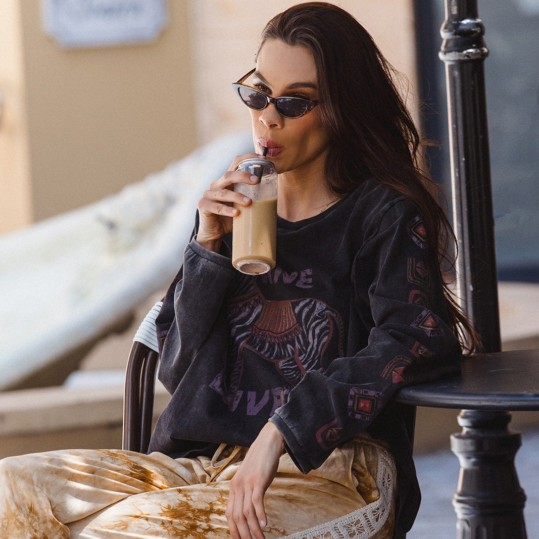 Lifestyle shot of Sunday Pants in sand showing tie-dye pattern and relaxed casual styling