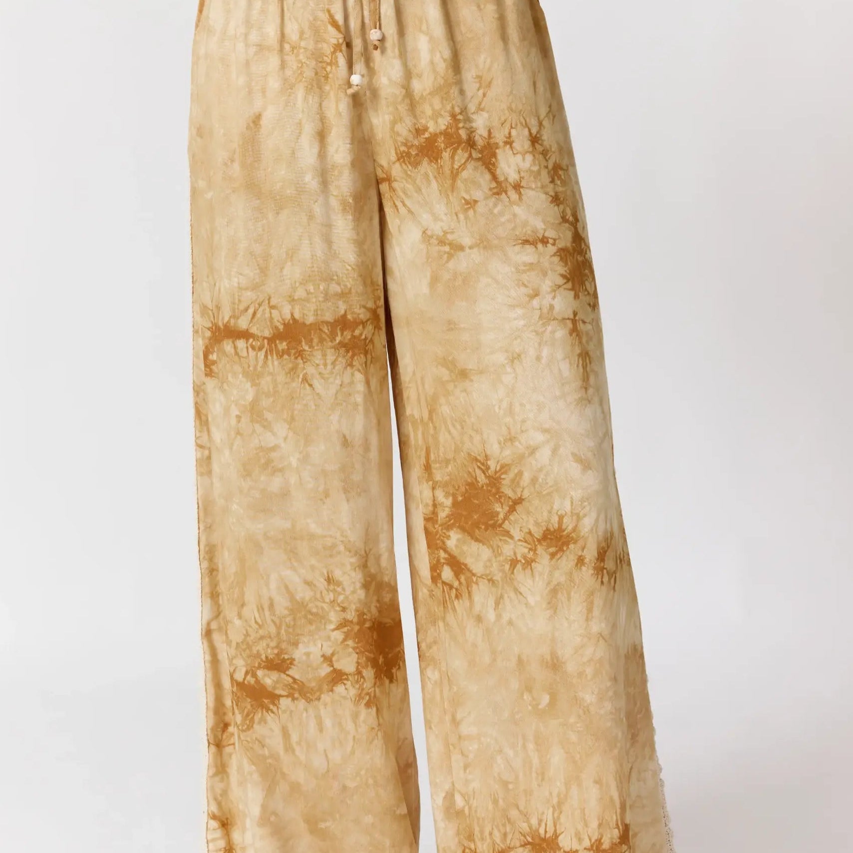 Front view of Sunday Pants in sand showing tie-dye pattern and wide leg silhouette with drawstring waist