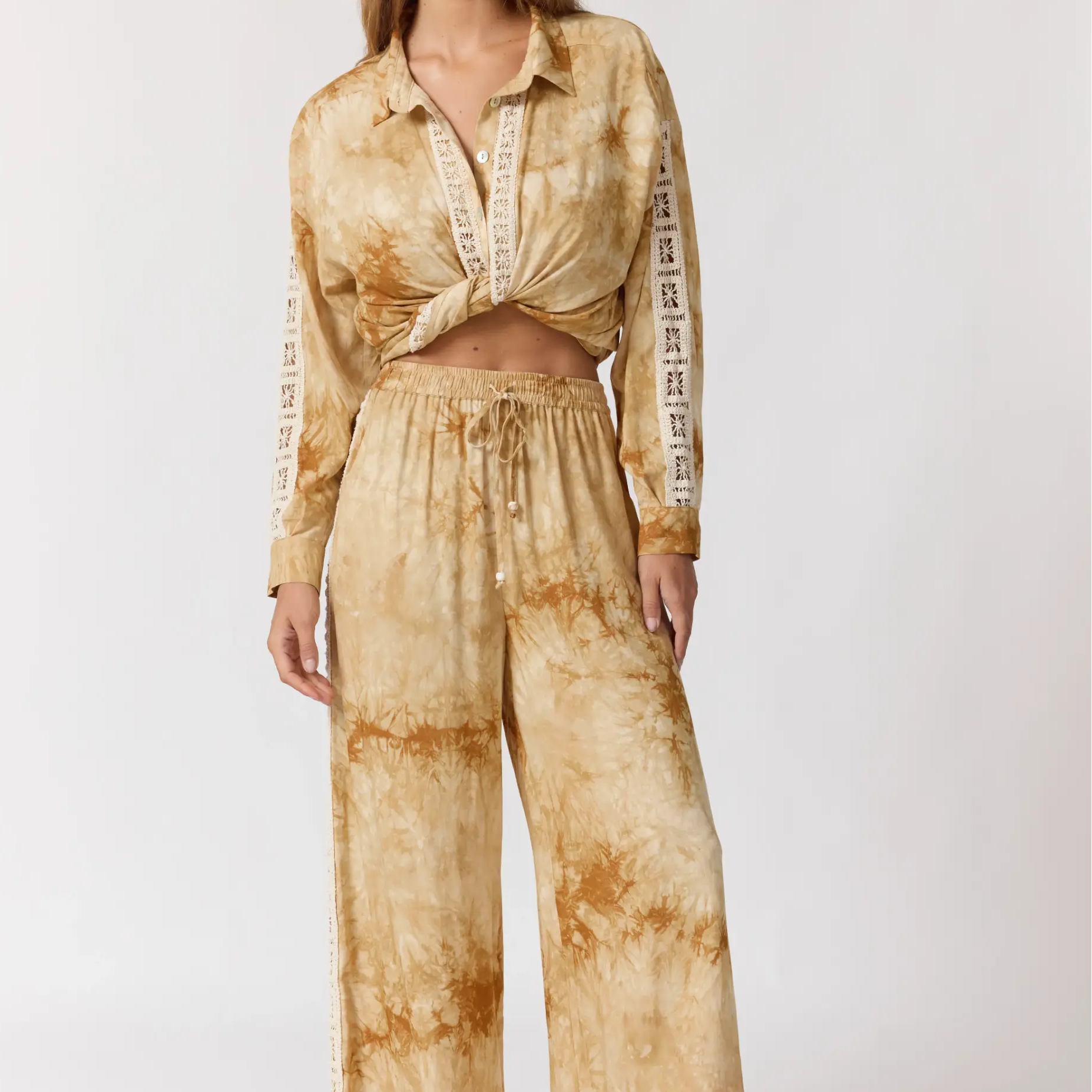 Full body front view of Sunday Pants in sand with tie-dye pattern and relaxed wide leg fit
