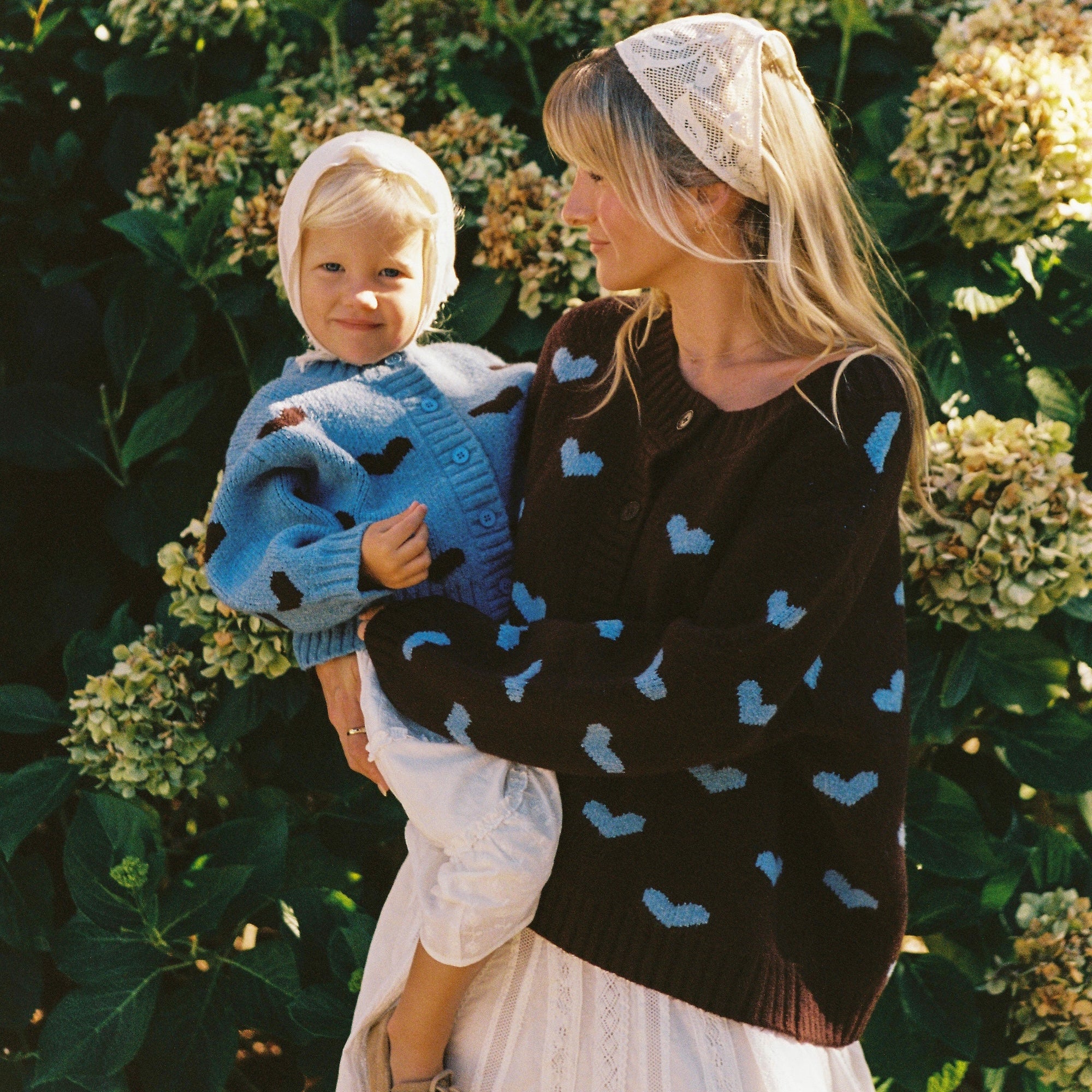 mum wearing Juni Hearts pattern knit cardigan relaxed fit button down and daughter wearing matching cardigan