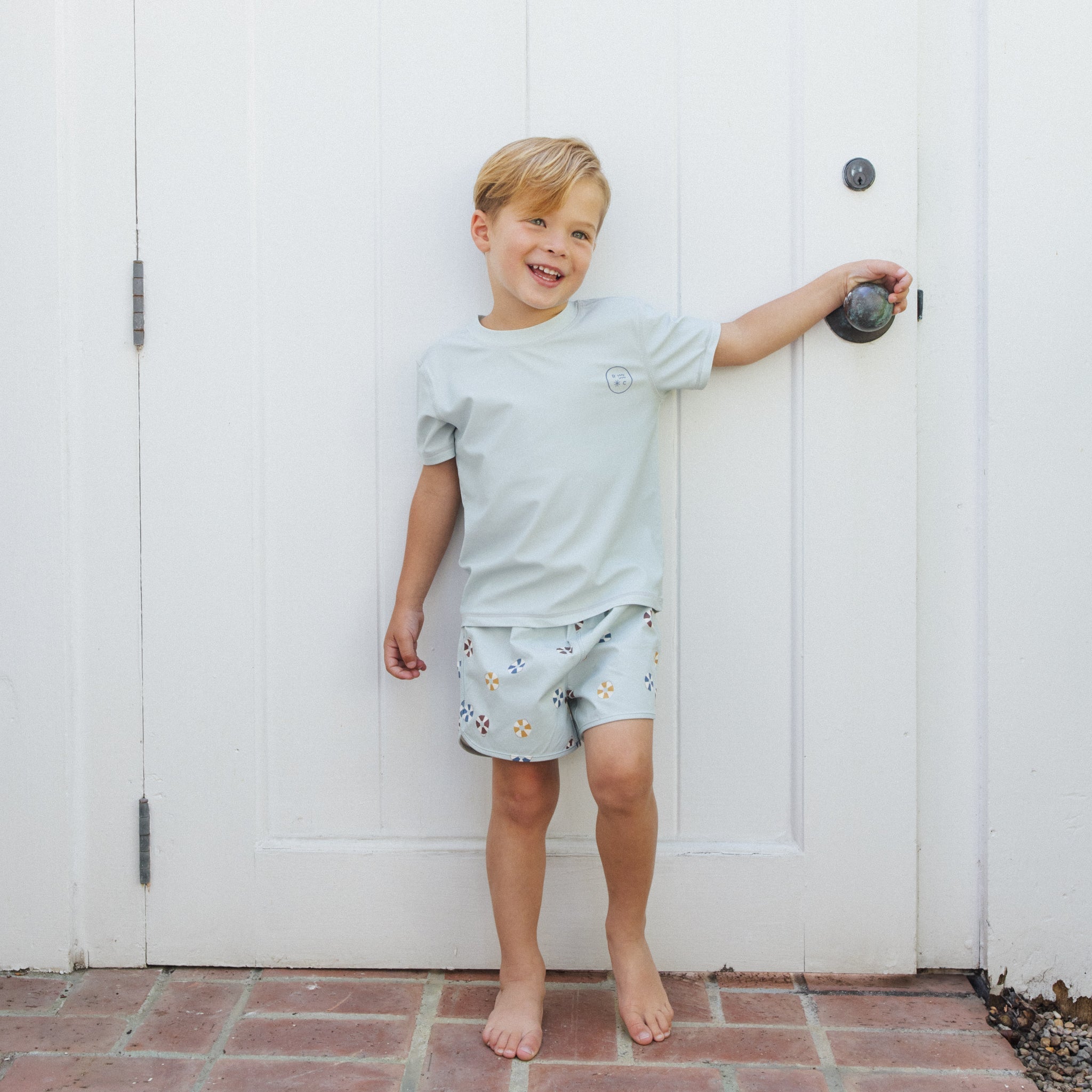 Front view of boy in Swim Trunk Floatie | Rylee + Cru