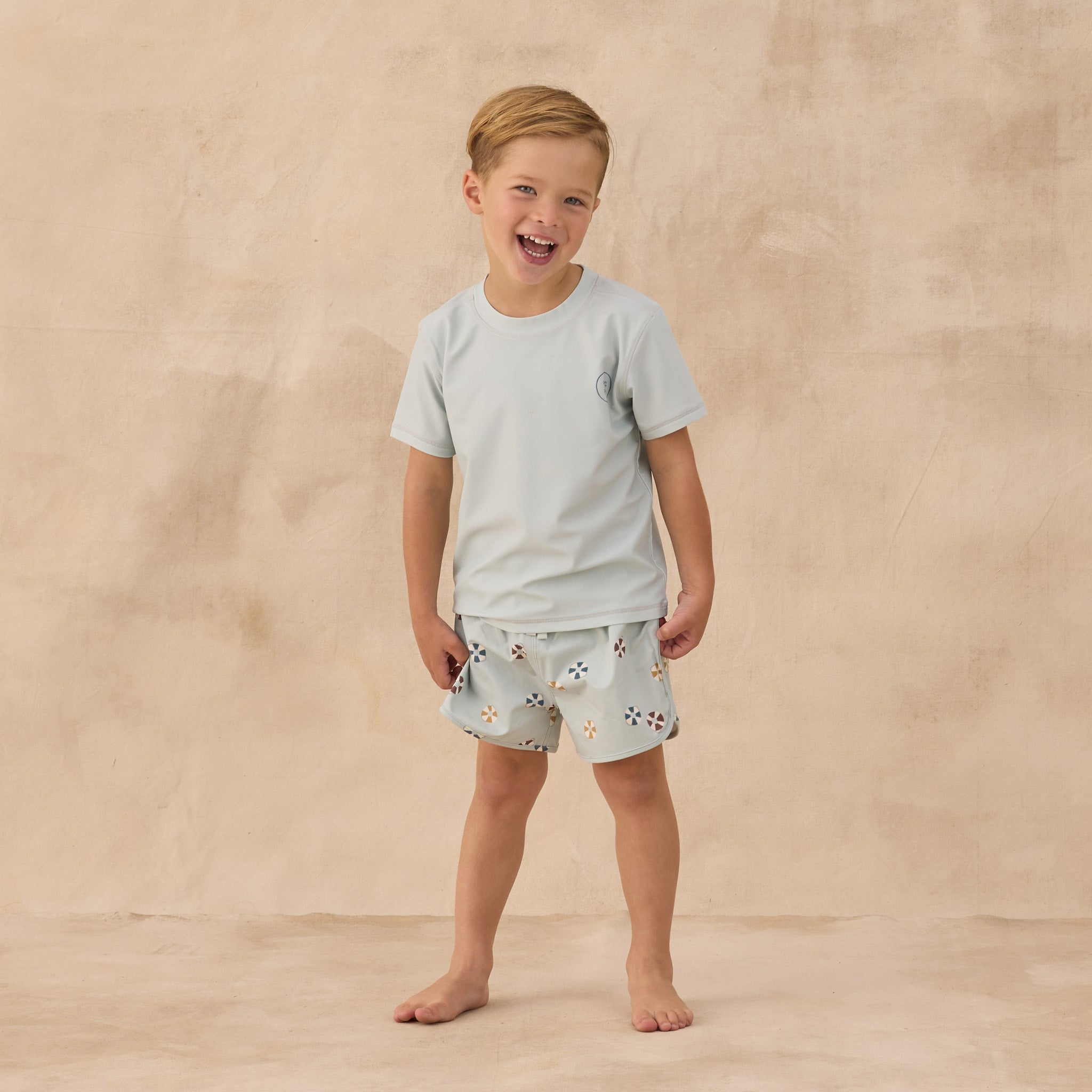 Boy wearing the Swim Trunk Floatie | Rylee + Cru