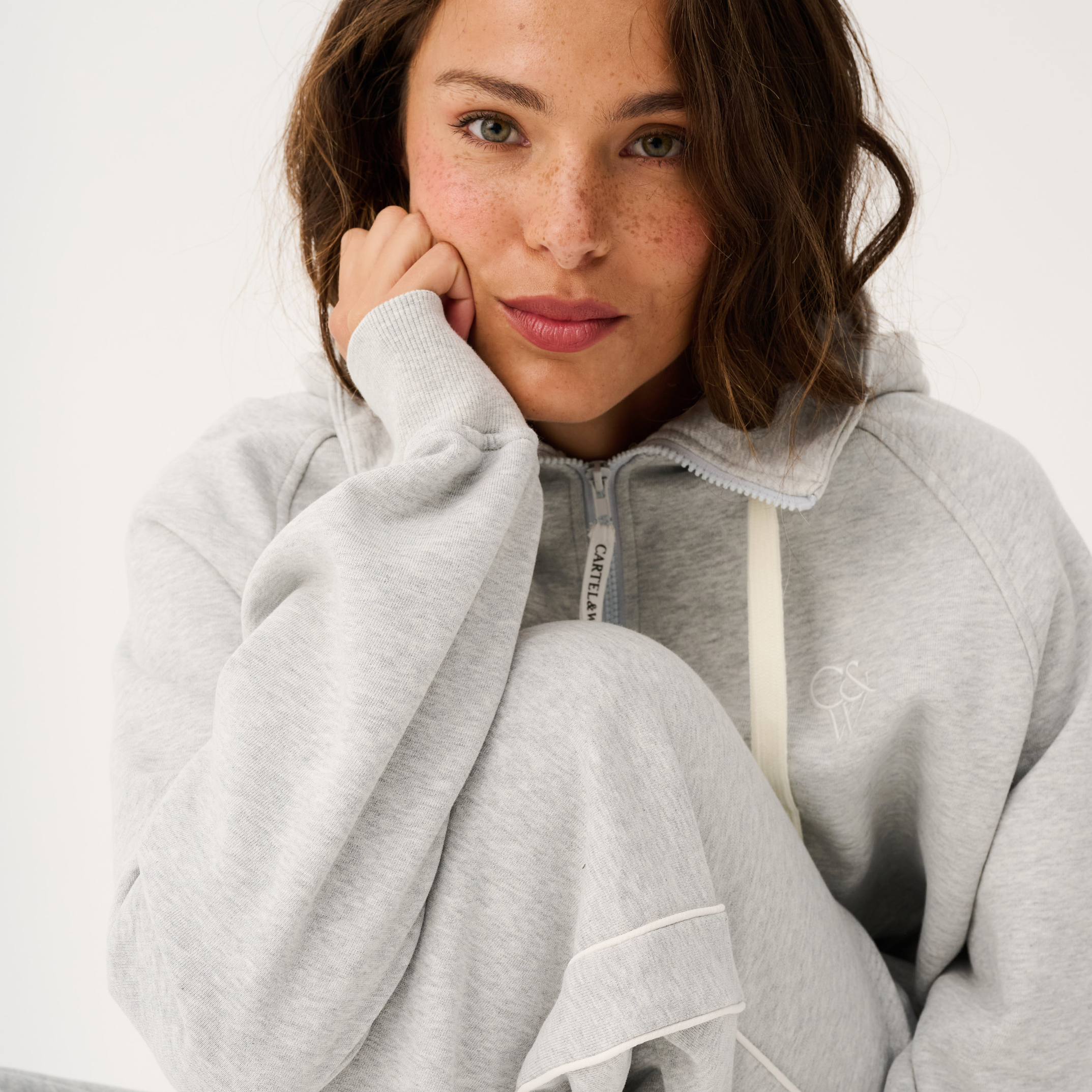Front view of Teagan Hoodie in grey marle showing quarter zip closure and relaxed fit