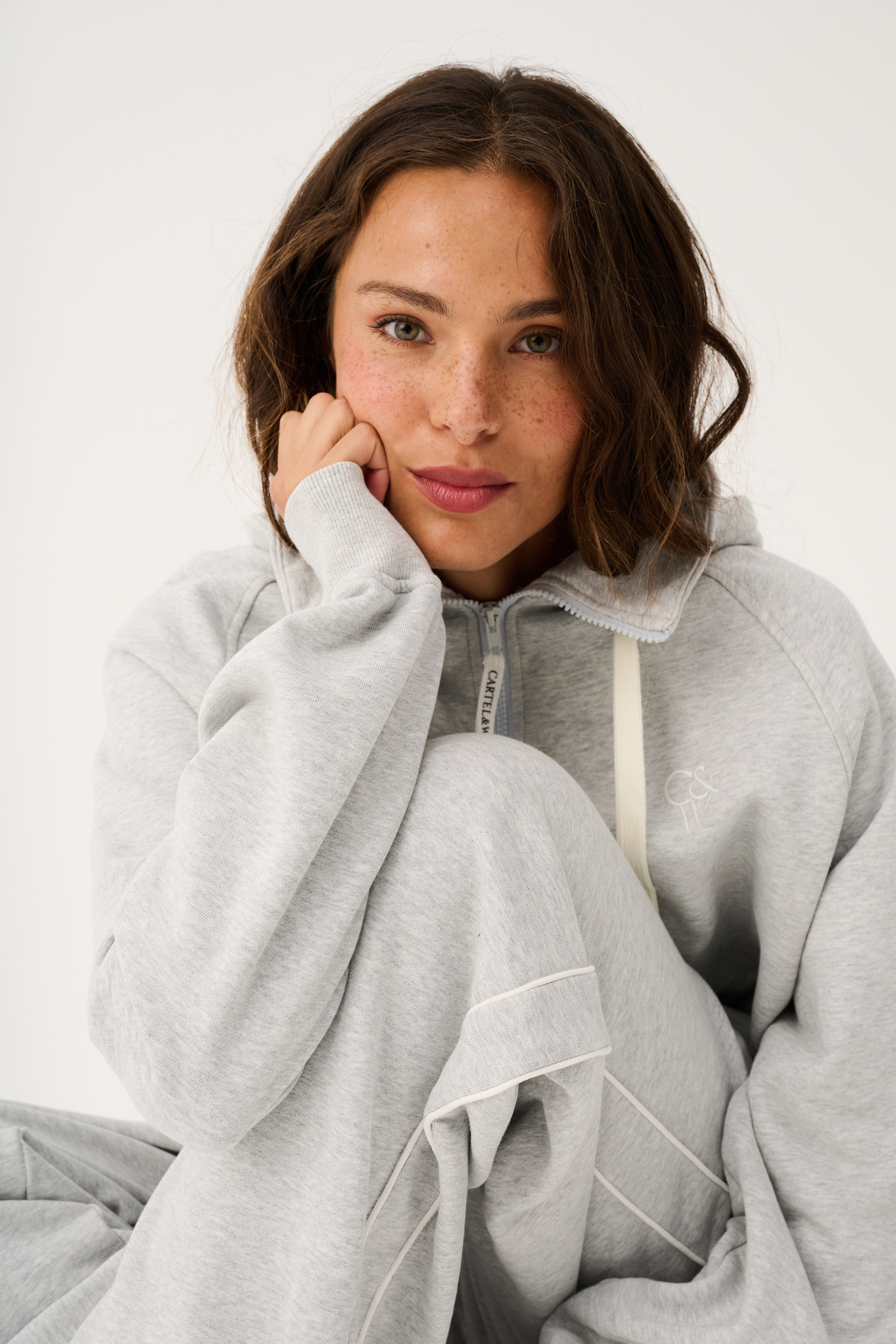 Front view of Teagan Hoodie in grey marle showing quarter zip closure and relaxed fit