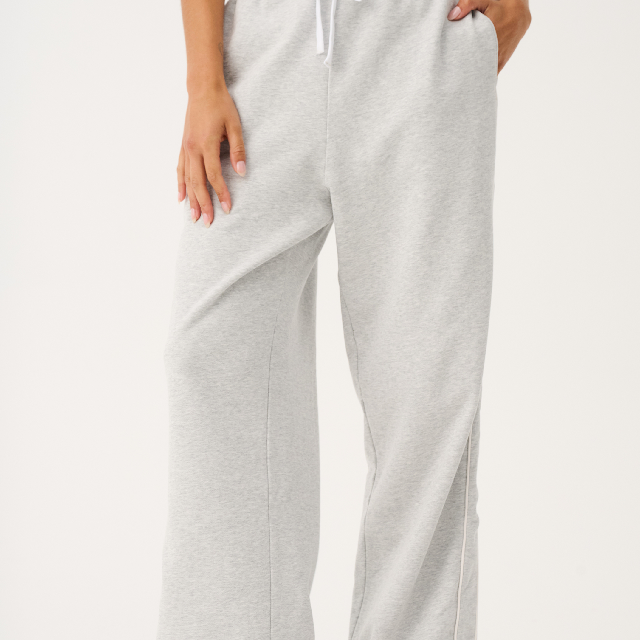 Front view of Teagan Track Pant in grey marle showing elastic waistband with white drawstring and side pockets
