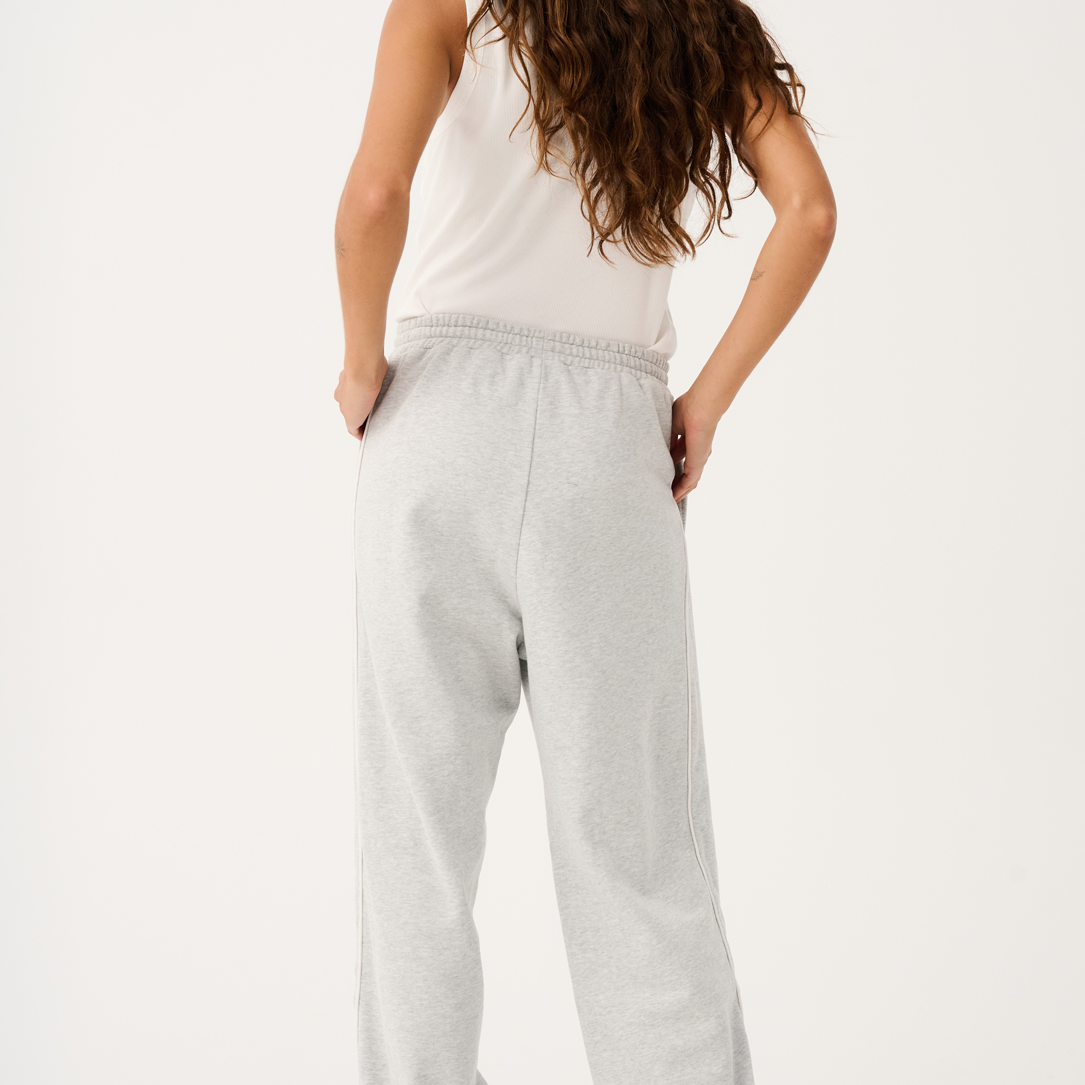 Back view of Teagan Track Pant in grey marle showing relaxed wide leg fit and elastic waistband detail