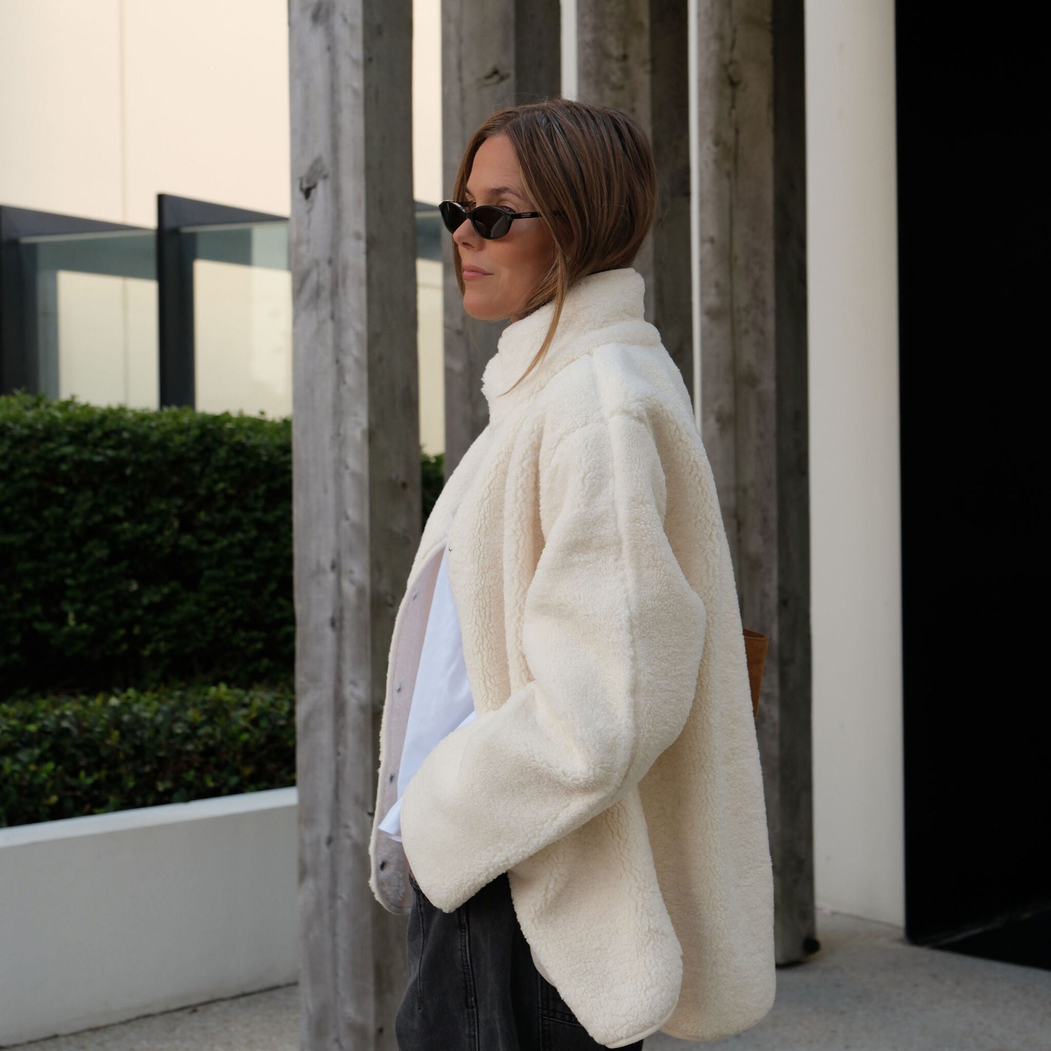 Side profile of woman in marshmallow teddy jacket showing relaxed oversized fit