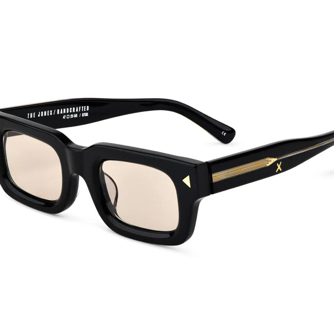 Black sunglasses with gold accents on a white background