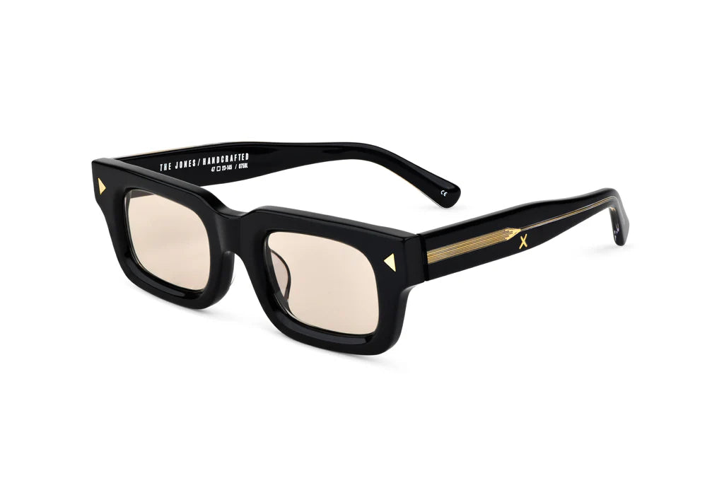 Black sunglasses with gold accents on a white background