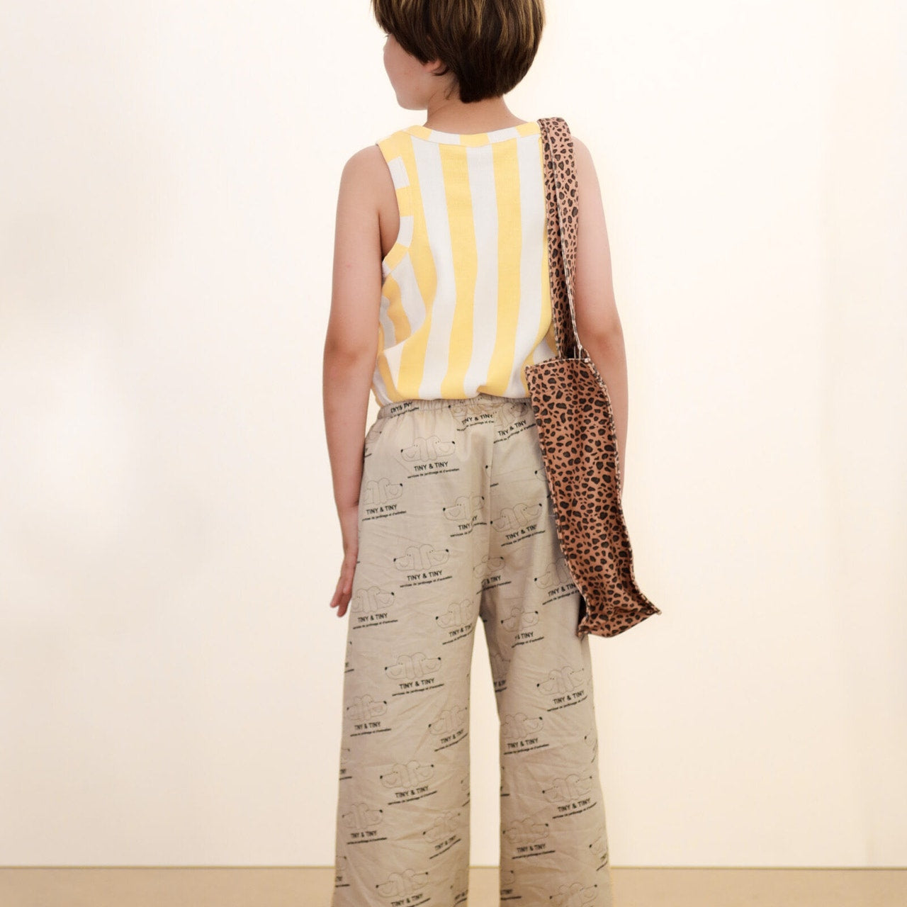 back of boy wearing Tiny & Tiny Twill Pant – Dark Vanilla by Tiny Cottons - beige pants with dog graphic