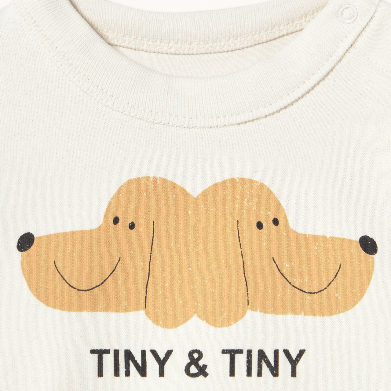 Close up of dog print on the Tiny & Tiny Baby Sweatshirt - Off-White | Tiny Cottons