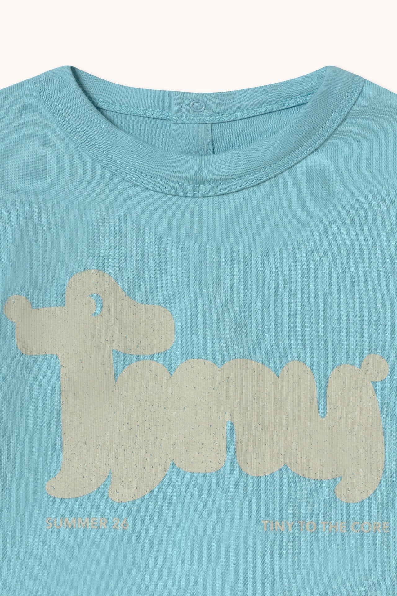 Close up of print and fabric on the Tiny Dog Graphic Baby Tee - Light Cyan | Tiny Cottons