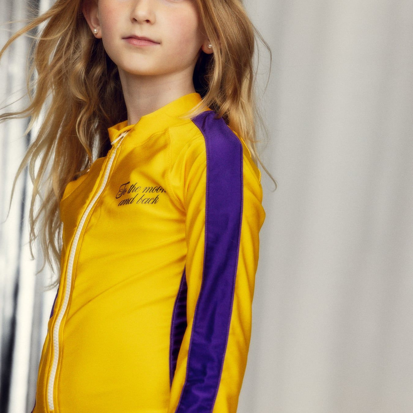 girl wearing To the Moon UV Swimsuit Yellow by Mini Rodini