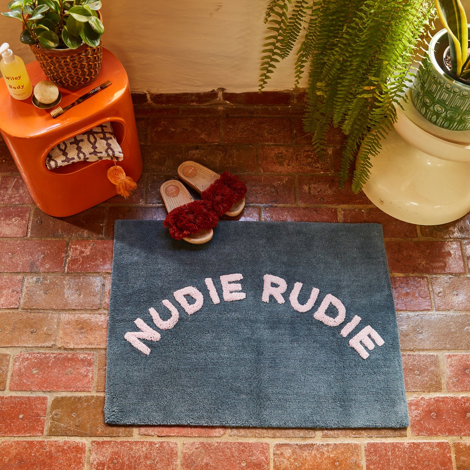 Tula Nudie Rudie Bath Mat – Denim by Sage & Clare - dark blue bath mat with the words "Nudie Rudie" in white