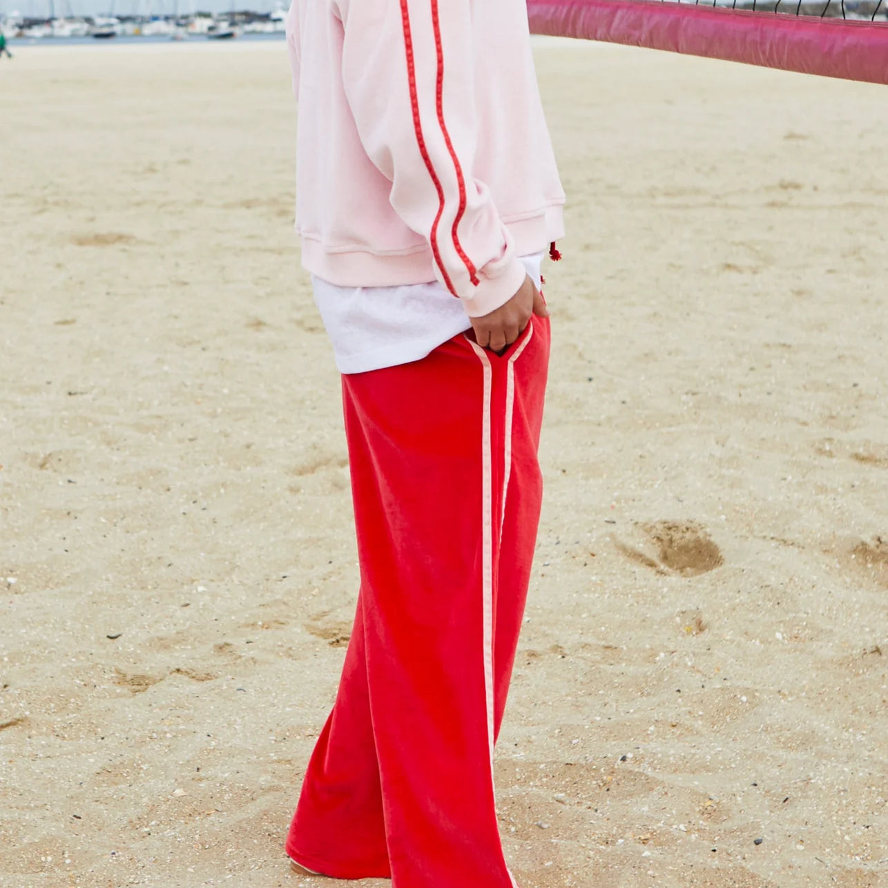 side view of model wearing Urban Velour Pant - Red/Pink by Hammill & Co