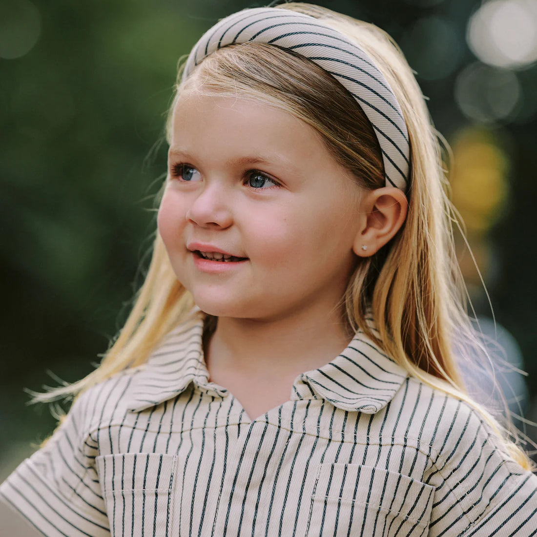 Girl wearing Utility romper navy pinstripe Rylee Cru