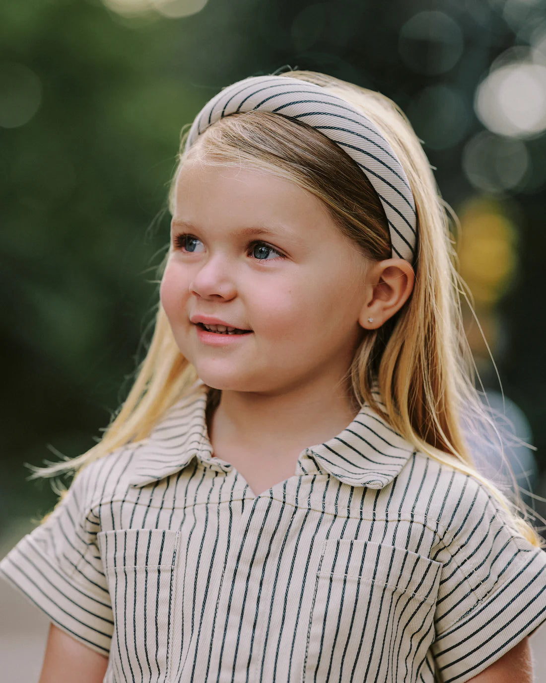 Girl wearing Utility romper navy pinstripe Rylee Cru