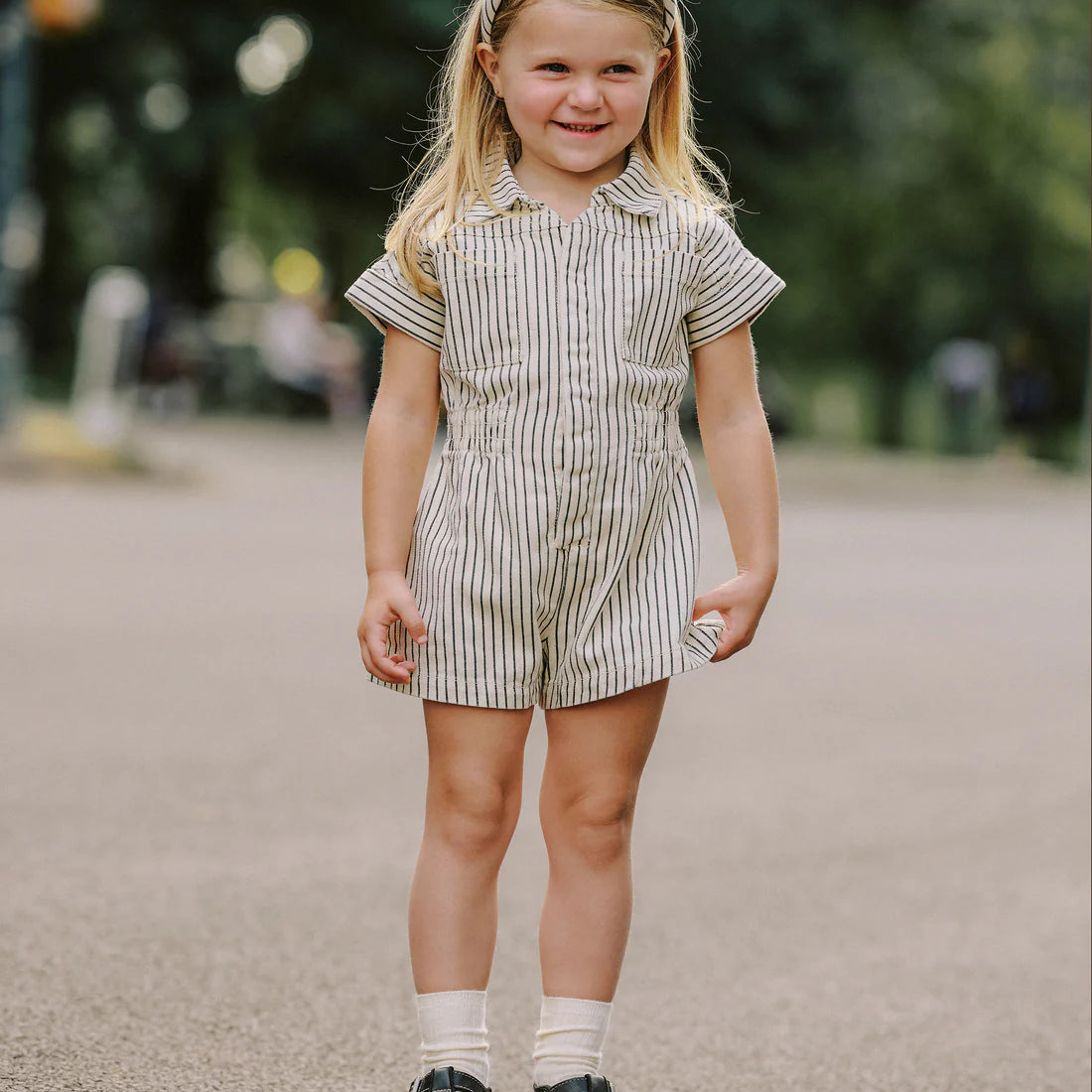 Girl wearing Utility romper navy pinstripe Rylee Cru - kids short sleeve boiler suit