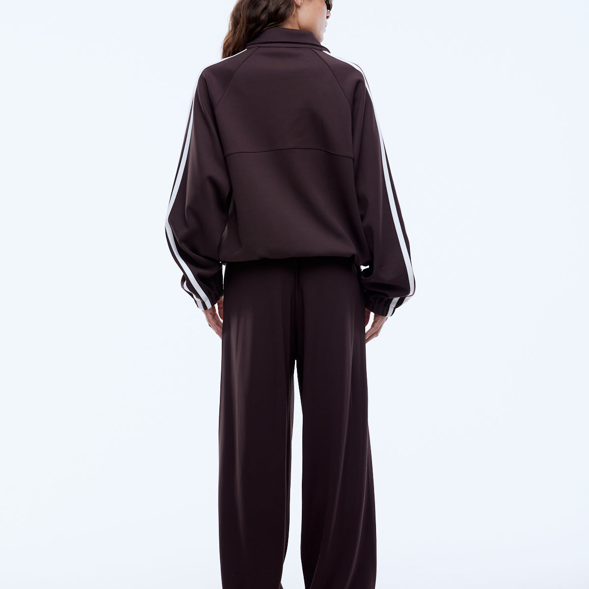 Welt pockets and stacked Ena Pelly logo prints detail on cocoa utility zip jacket