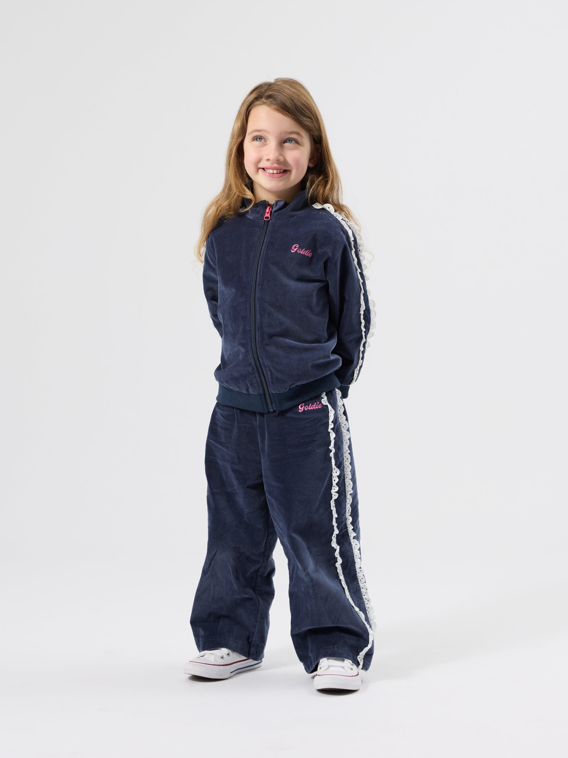 Navy velour broderie wide leg pants with white lace trim shown in full tracksuit outfit