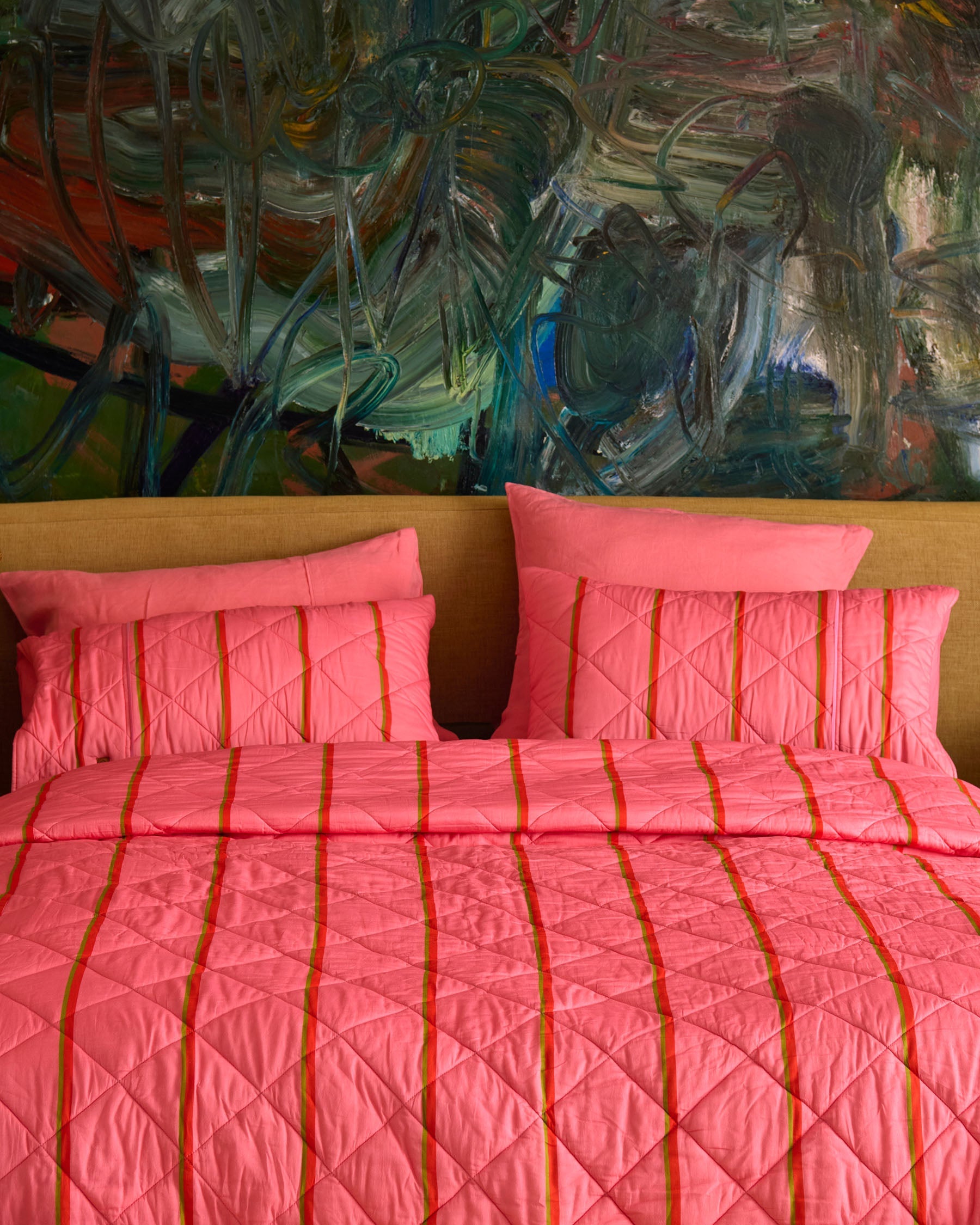 Front view of Wategos Soiree Stripe organic cotton quilted bedspread showing pink color and orange stripe pattern