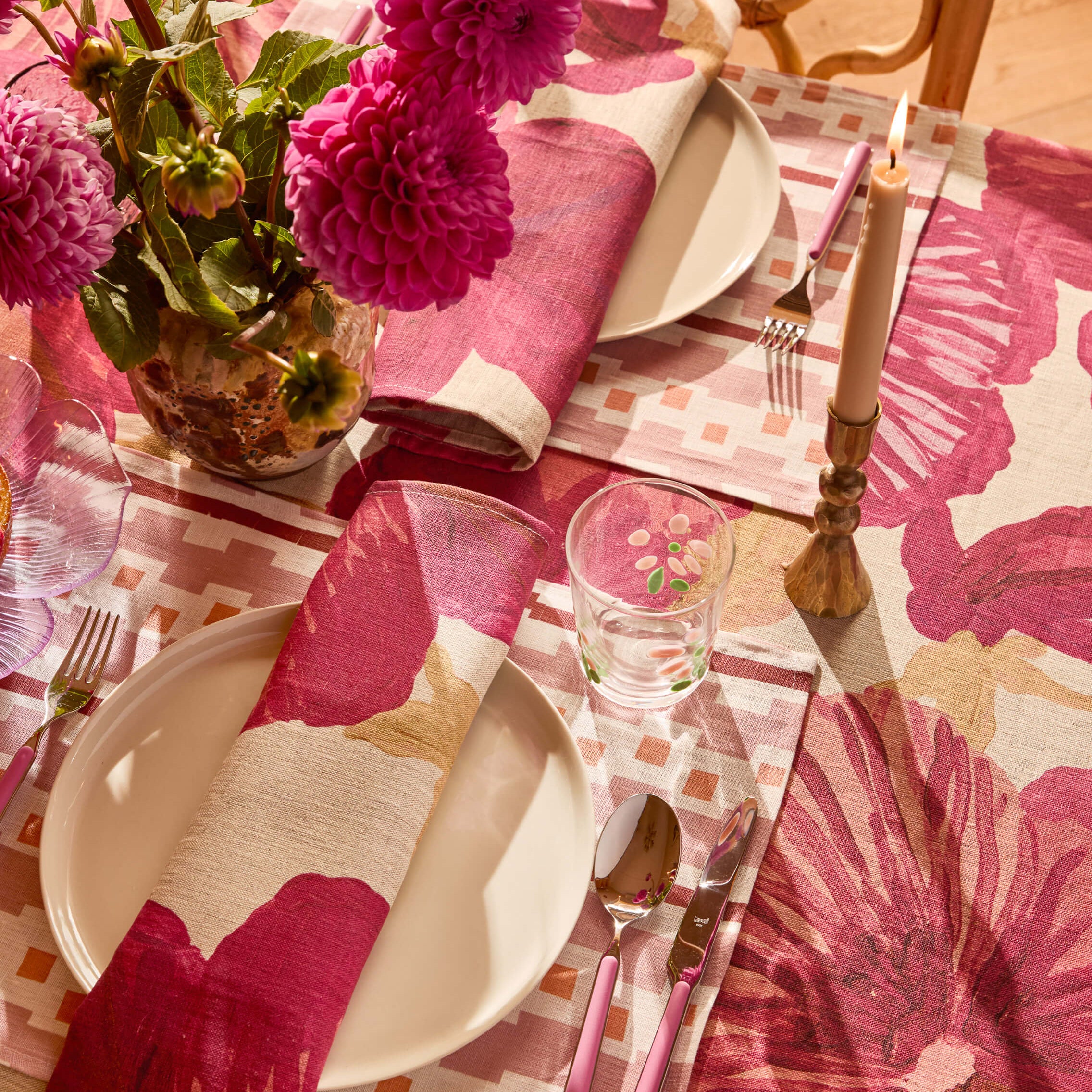 Close-up of Wild Pansy Pink napkin showing detailed floral pattern and checkered border design