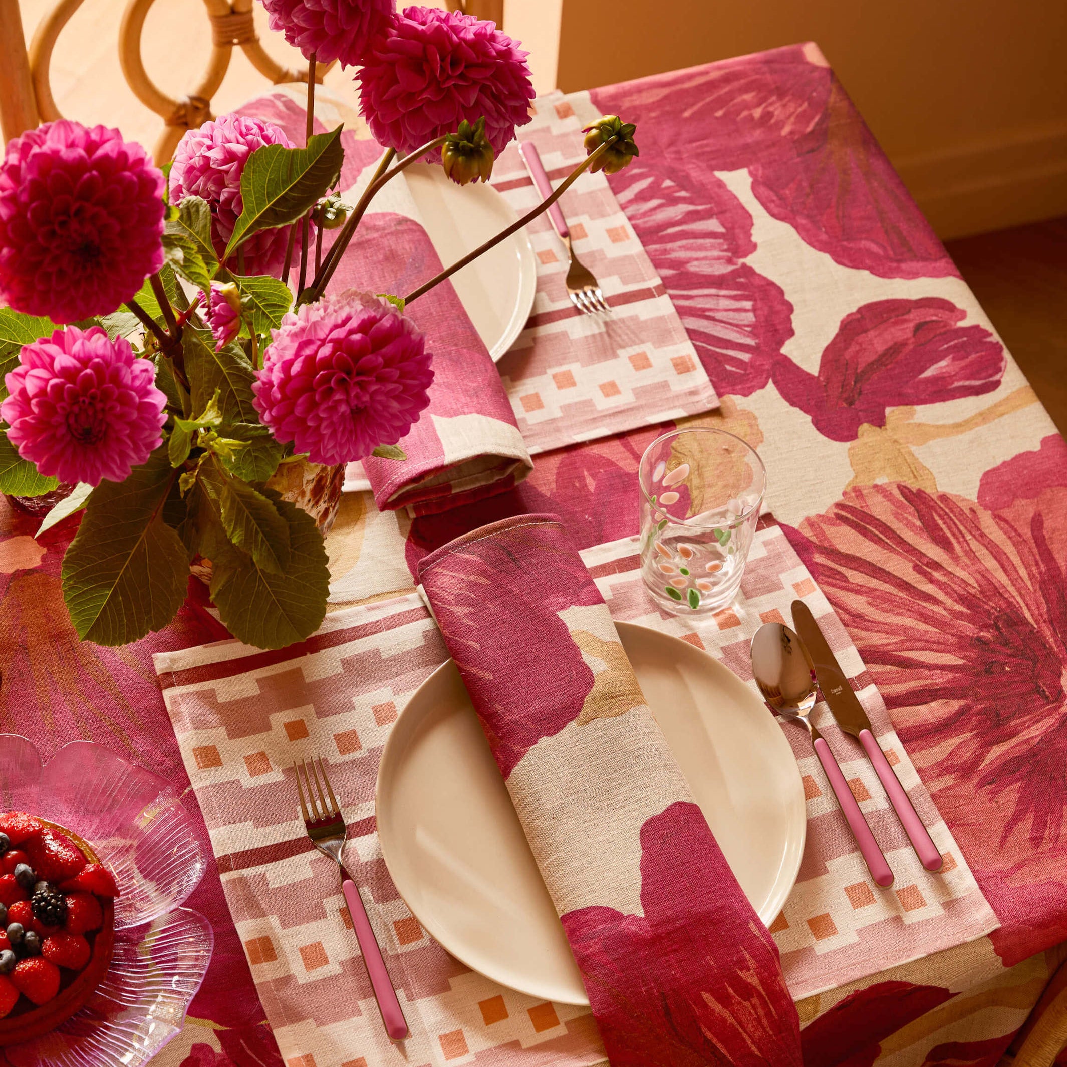 Close-up angled view of Wild Pansy Pink Tablecloth showing large floral pattern detail