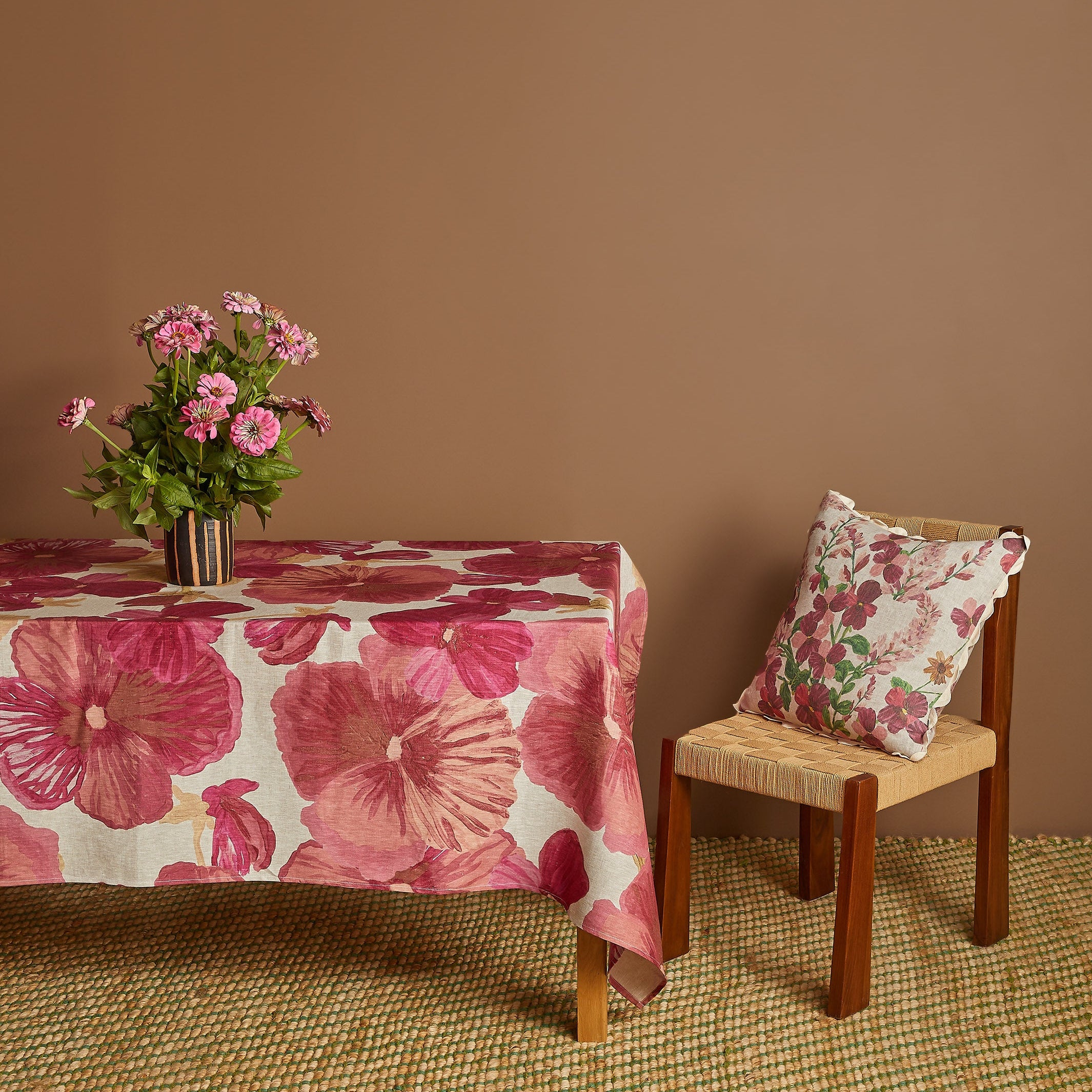 Side view of Wild Pansy Pink Tablecloth draped over table edge showing full pattern coverage
