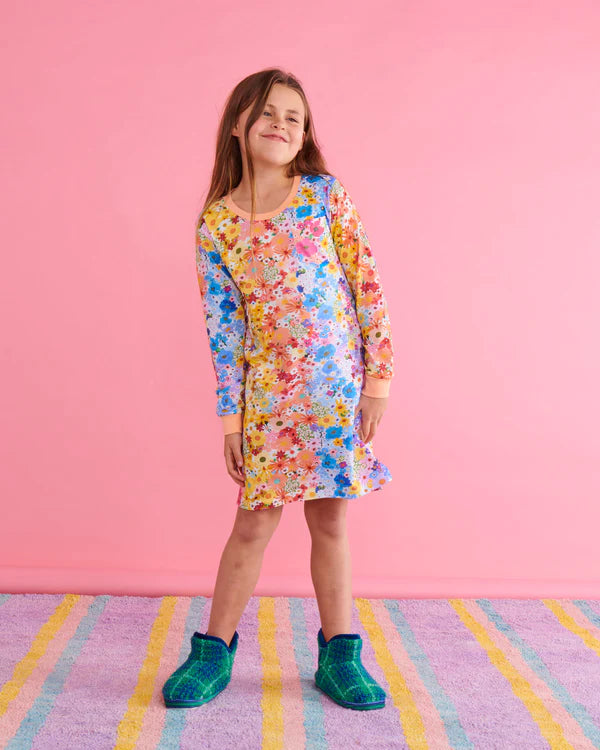 Girl model wearing Kip & Co Pyjamas and Widerness tartan sherpa kids ankle boots by Kip & Co