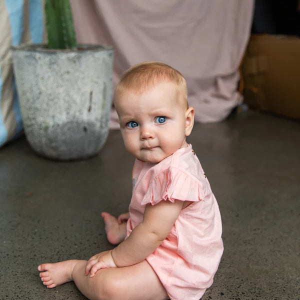 baby wearing cotton pink baby onesie