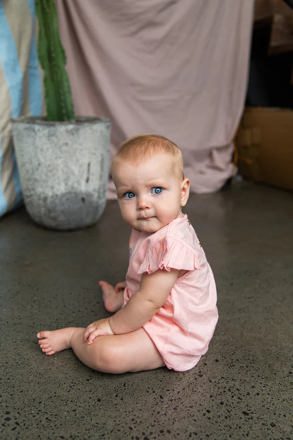 baby wearing cotton pink baby onesie