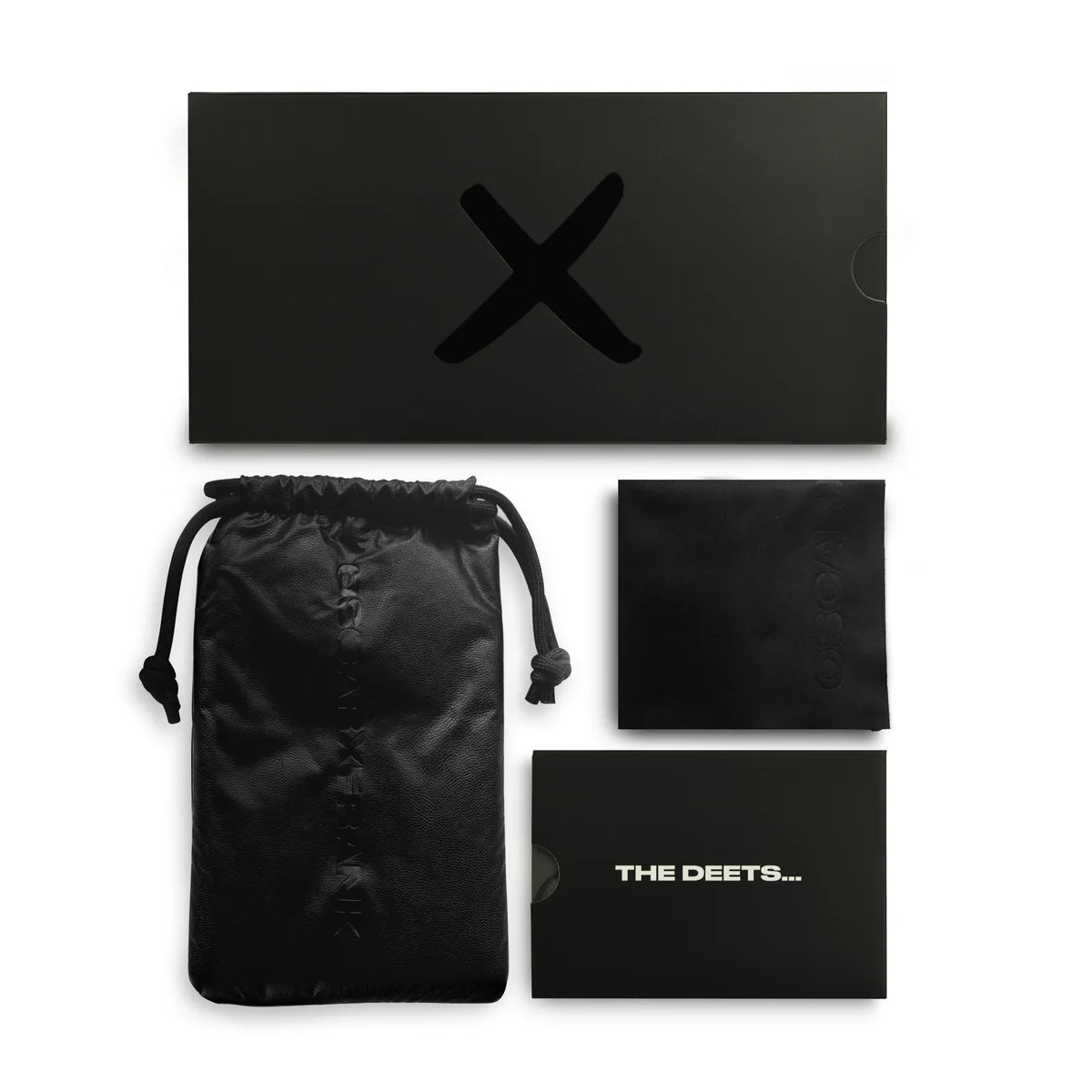 Black product packaging set with drawstring bag, card, and box on a white background